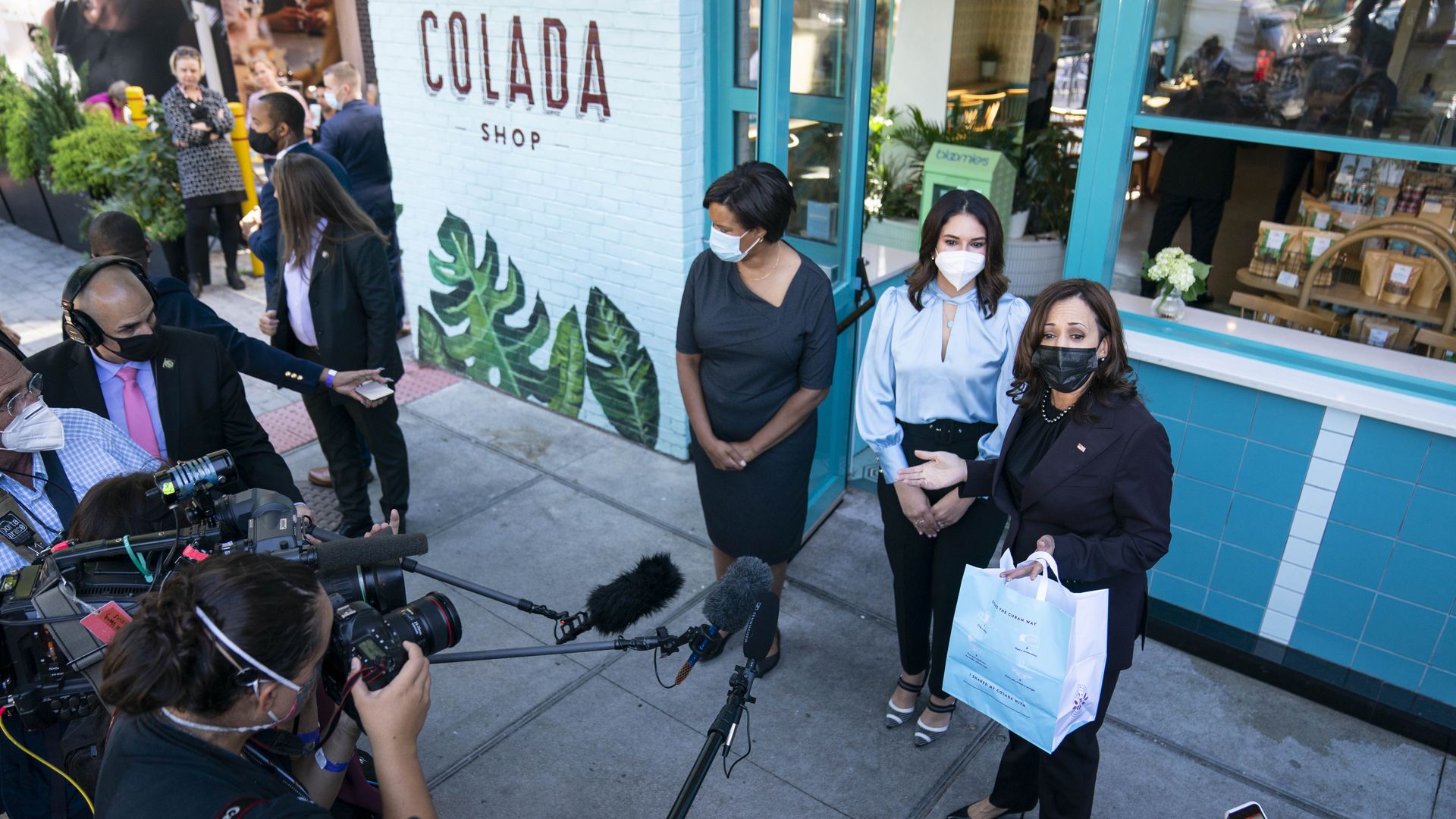 Vice President Kamala Harris is seen speaking with reporters outside a Cuban coffee shop in Washington.