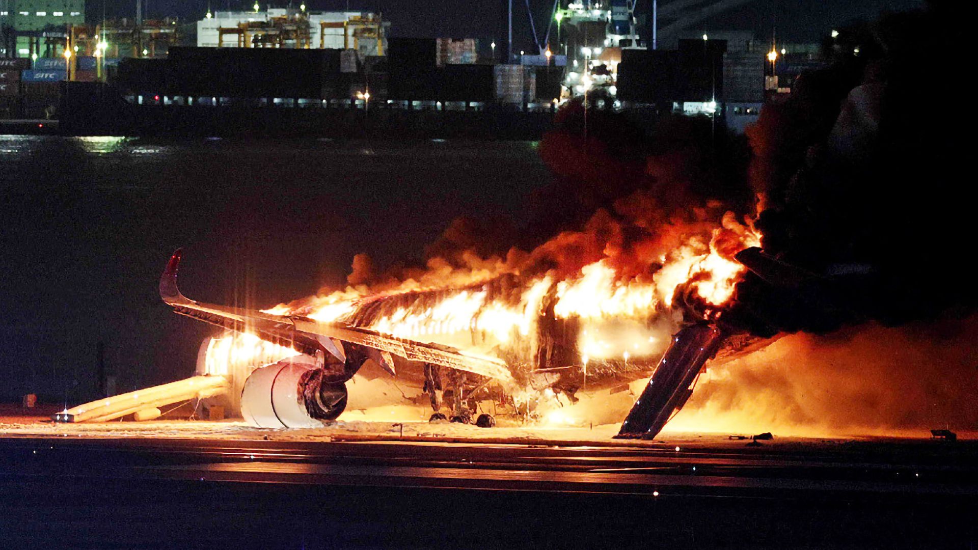 Japan Airlines Flight 516 ablaze at Tokyo's Haneda Airport on January 2, 2024. Photo: STR/JIJI PRESS/AFP via Getty Images