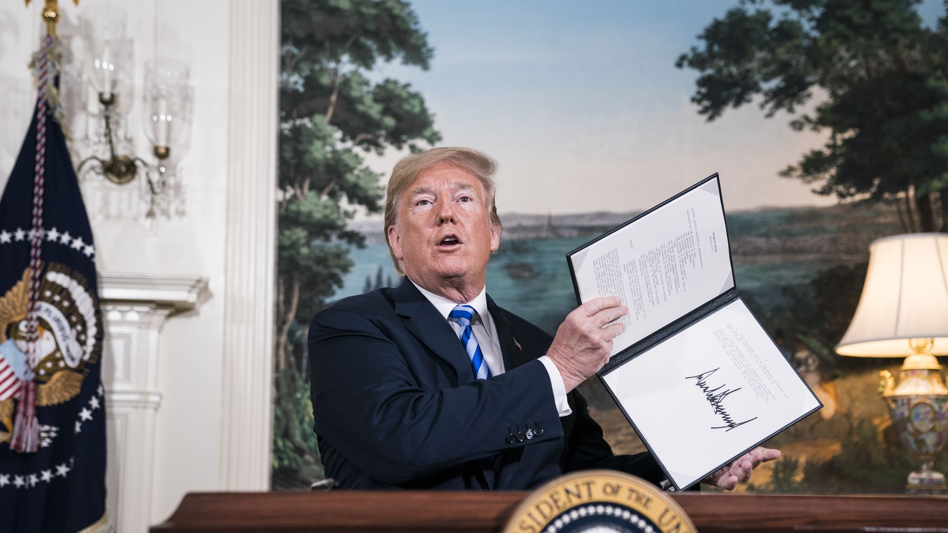 President Donald J. Trump signs a National Security Presidential Memorandum as he announces the withdrawal of the United States from the Iran nuclear deal