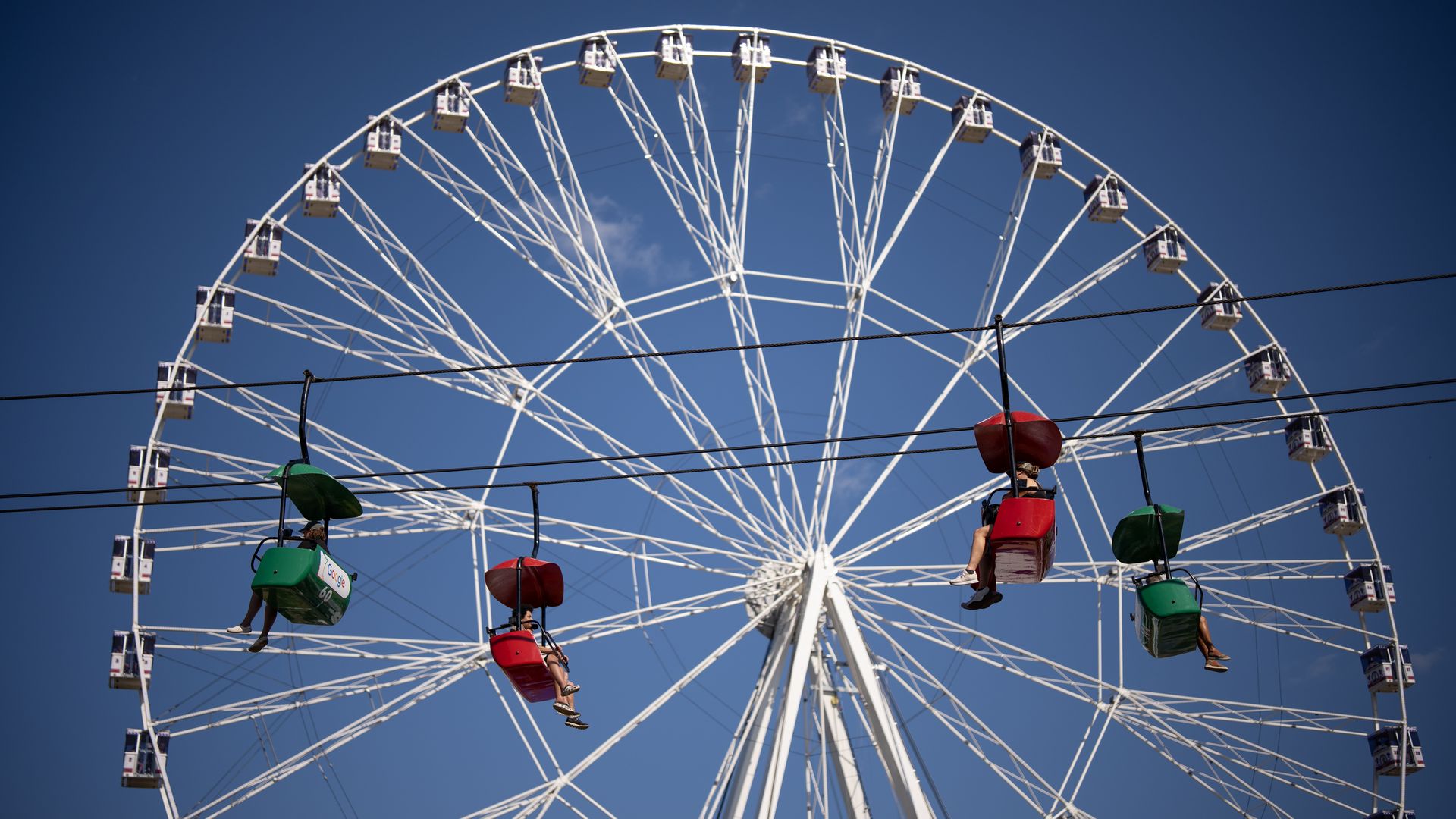 A ferris wheel beyond a chairlift