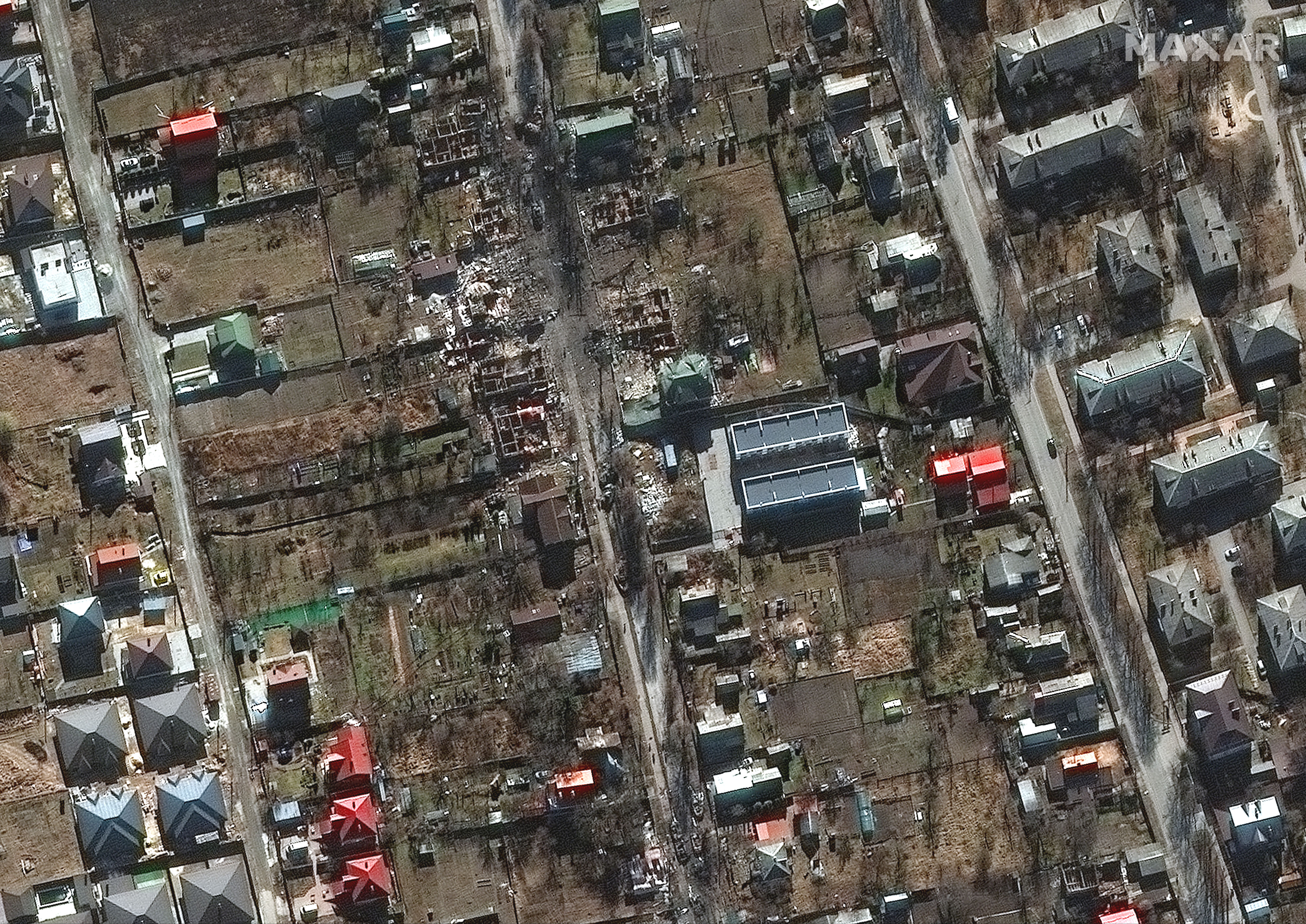 Close up images of a destroyed military vehicles and houses in a residential area south of Antonov Airport.
