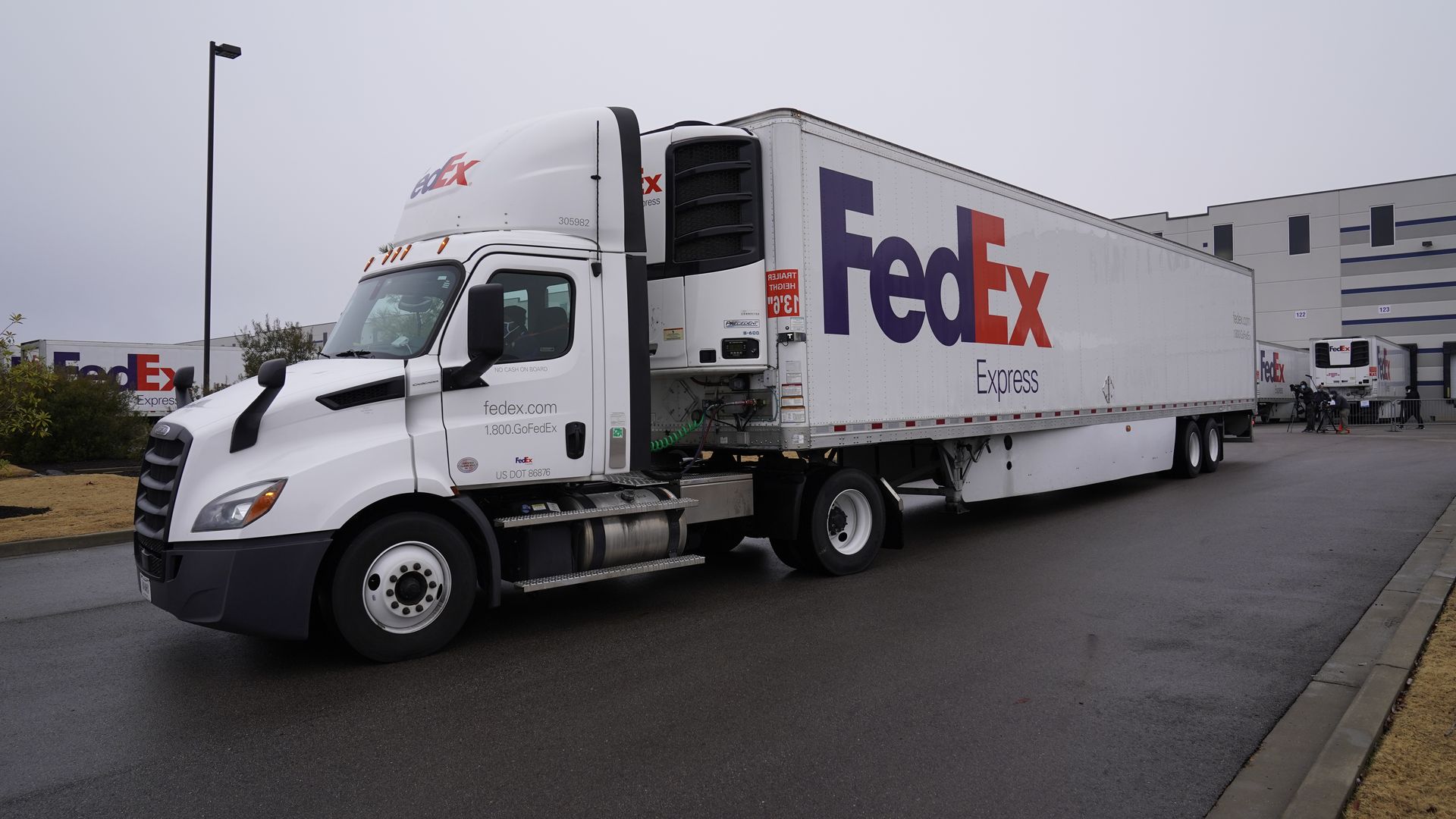 Image of a FedEx truck pulling out of Moderna's vaccine plant.