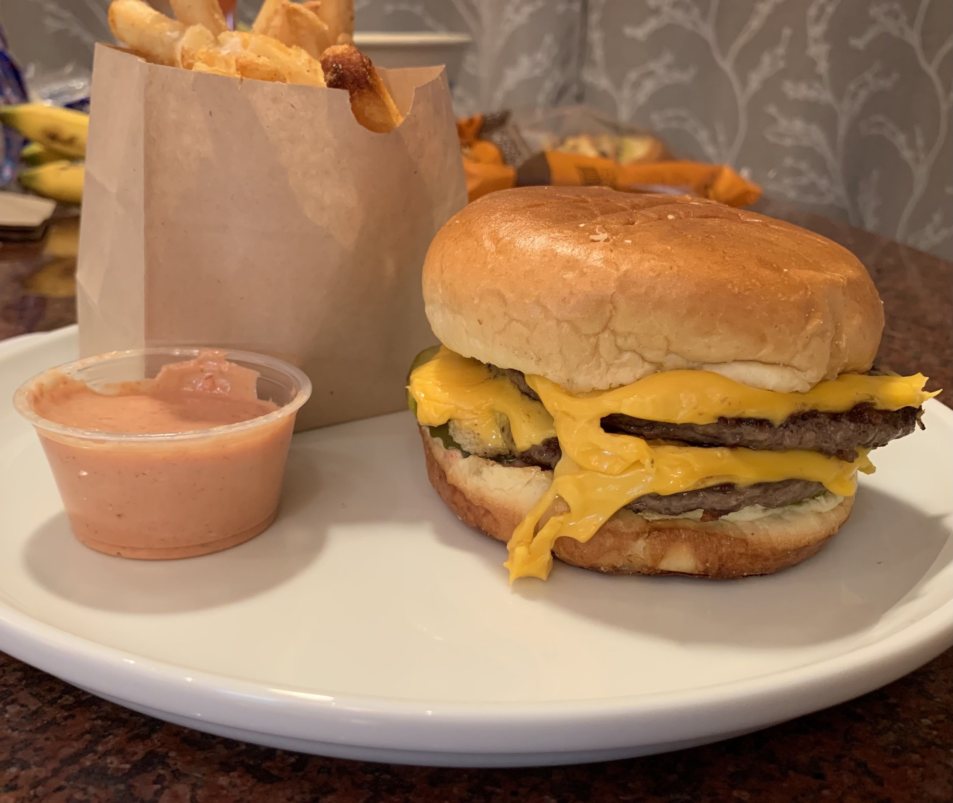Photo of cheeseburger and fries on a plate. 