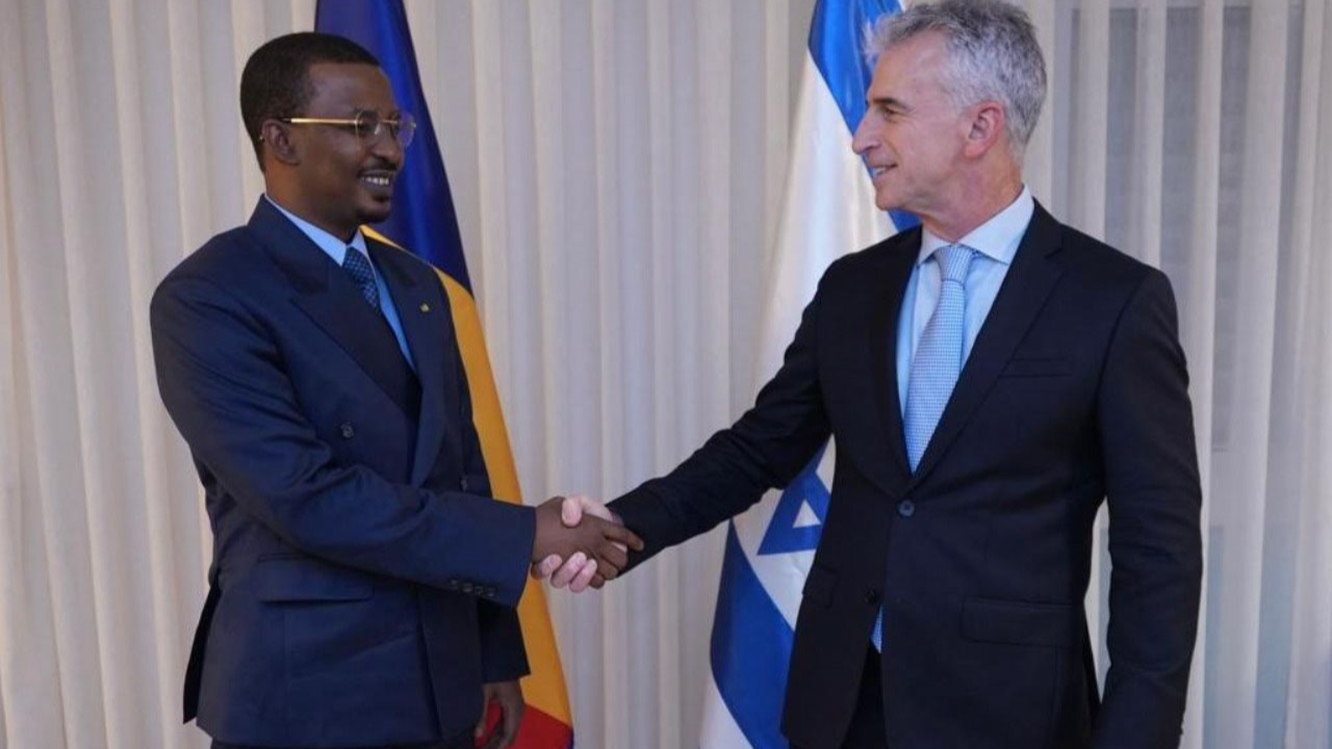 Mossad director and Chad's president shake hands.