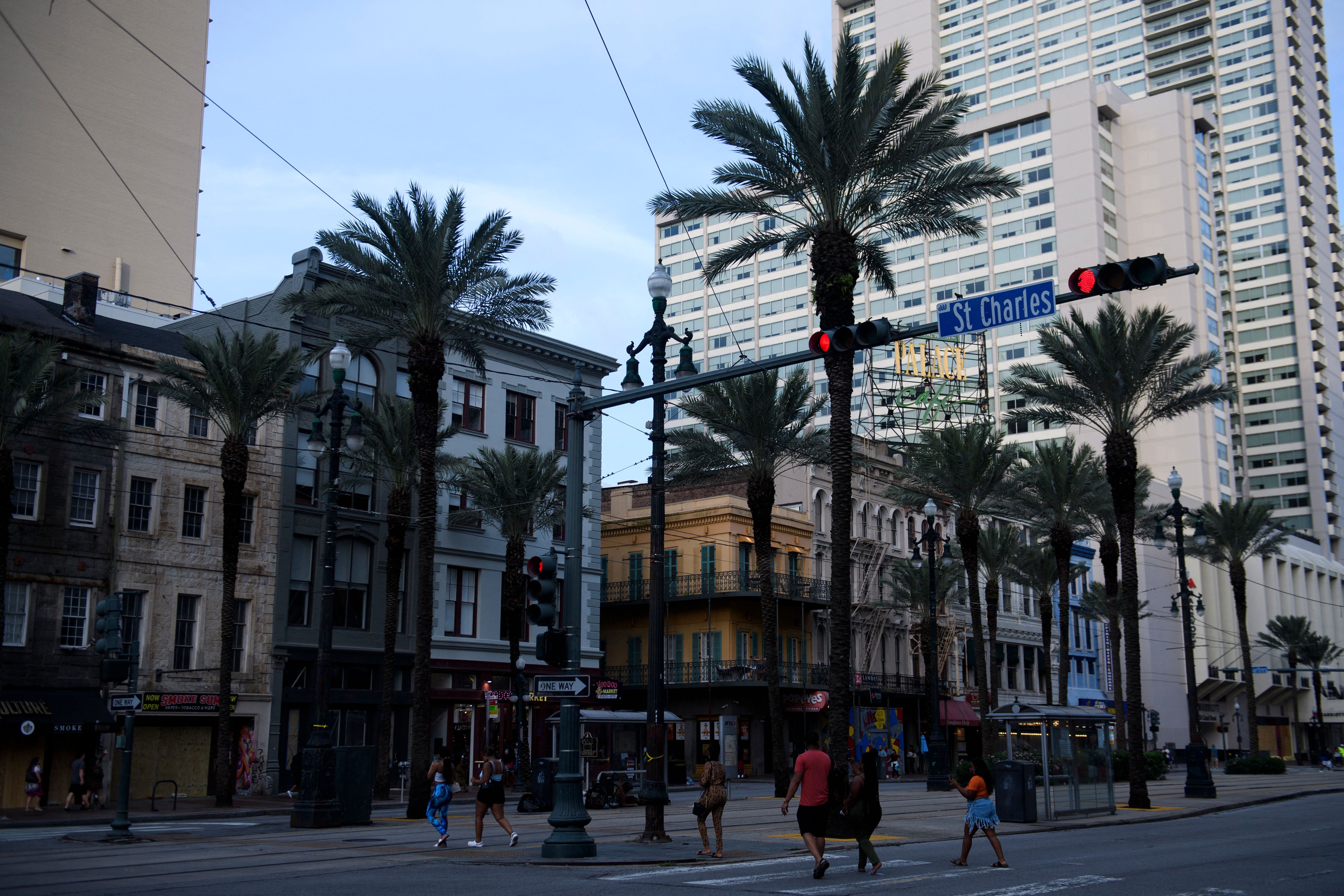 Image shows pedestrians walking across Canal Street.