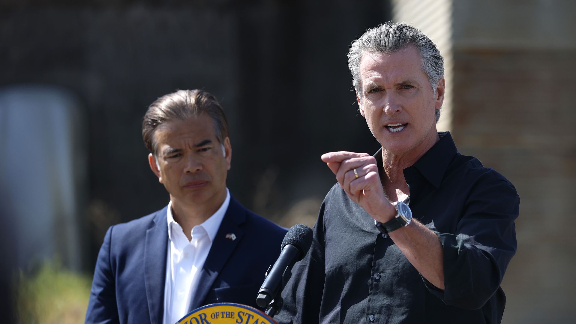 California Governor Gavin Newsom (R) speaks as California Attorney general Rob Bonta looks on during a news conference at Gemperle Orchard on April 16, 2025 in Ceres, California. Governor Gavin Newsom and California Attorney General Rob Bonta have filed a lawsuit in federal court challenging the Tru