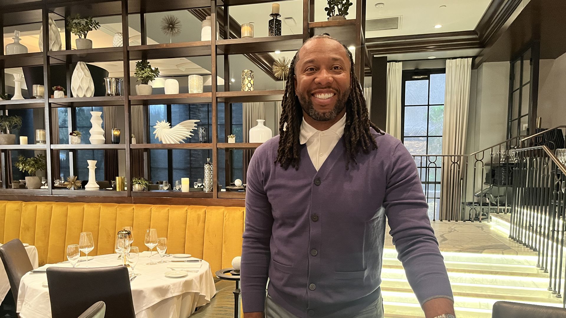 A man smiling in a restaurant. 