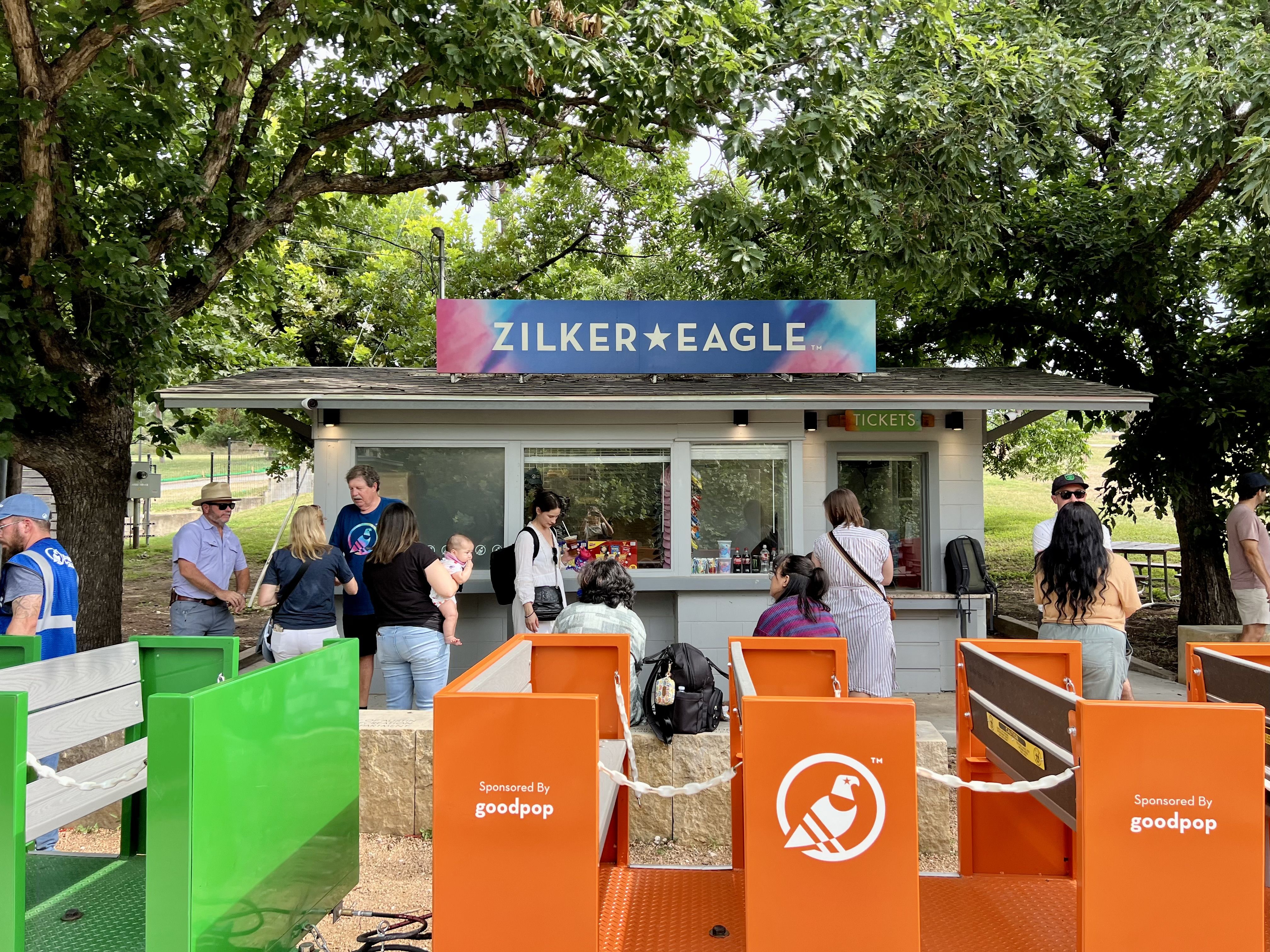 A photo of the train depot, with the Zilker Eagle in the foreground and the depot in the background.