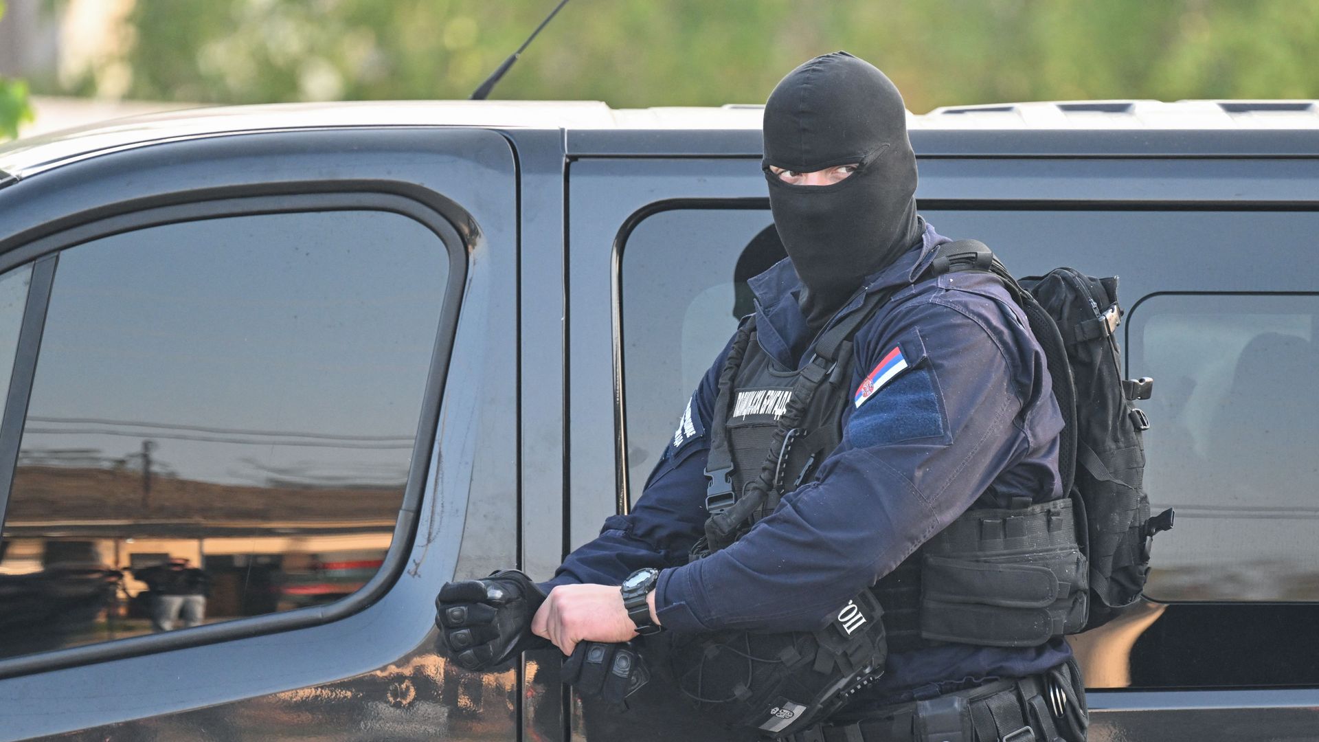A masked policeman secures an area in the village of Dubona near the town of Mladenovac, about 60 kilometres (37 miles) south of Serbia's capital Belgrade, on May 05