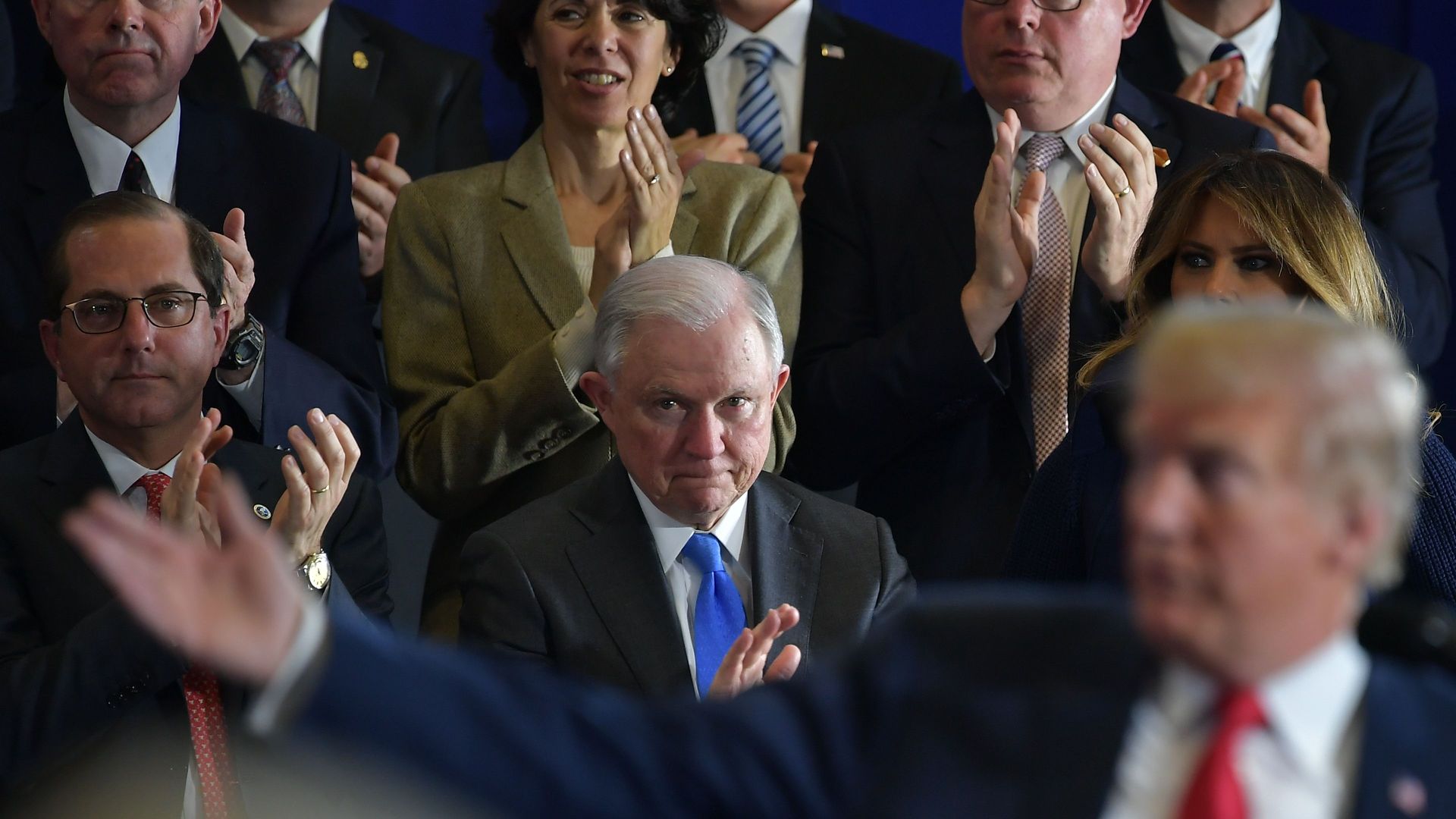 Jeff Sessions claps and looks on as Trump talks with his right hands stretched out