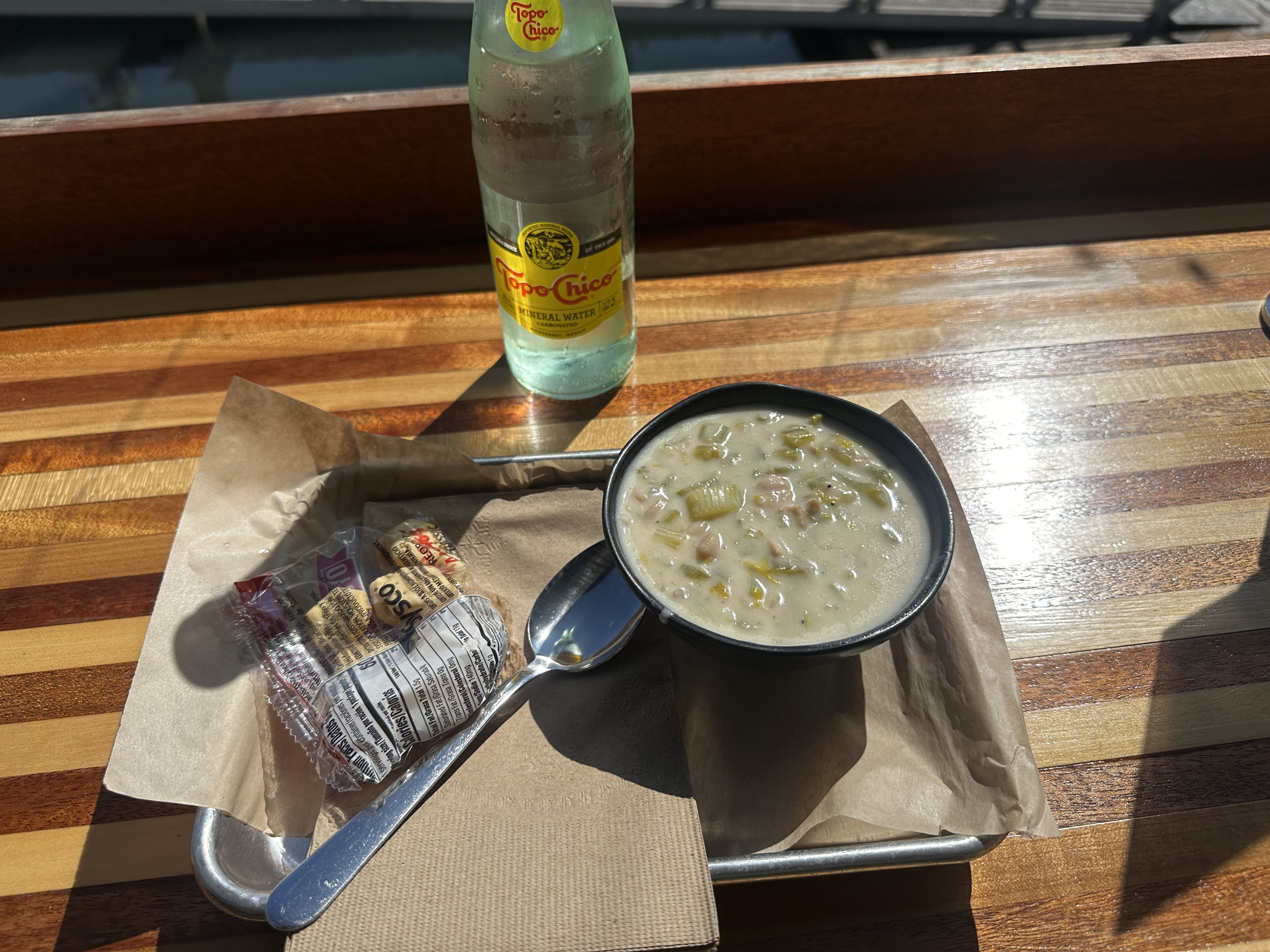 A bowl of clam chowder on a wooden table