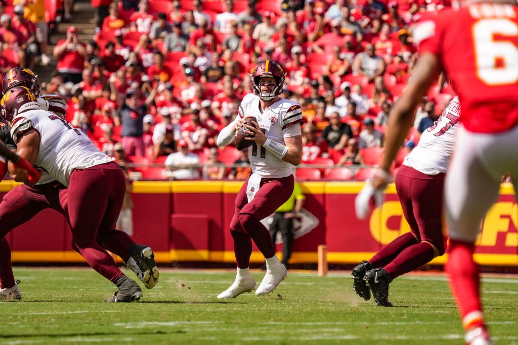 Carson Wentz #11 of the Washington Commanders drops back to throw during the second quarter of the game against the Kansas City Chiefs at Arrowhead Stadium on August 20, 2022