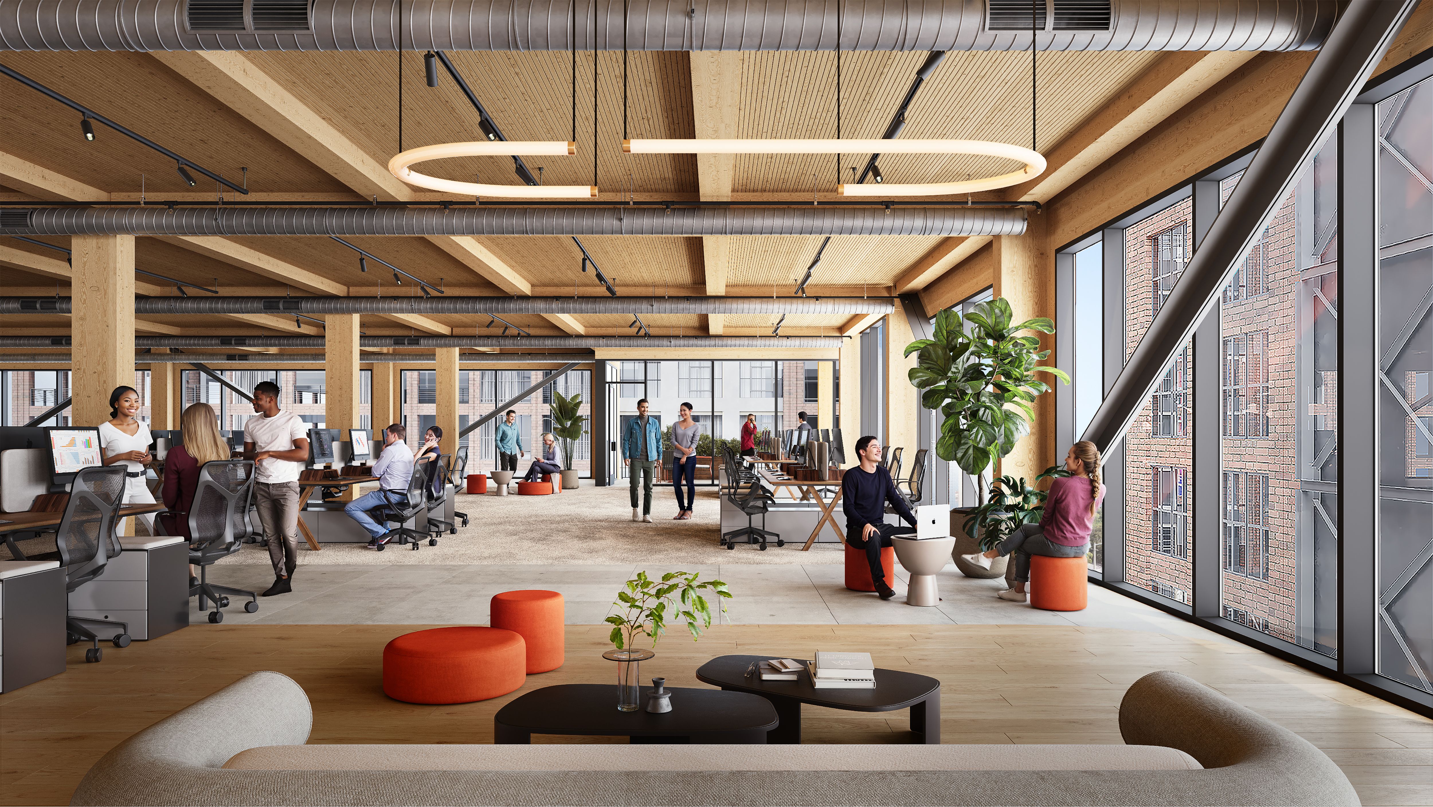 A bright open-plan office with exposed wooden beams, industrial ducts, and large floor-to-ceiling windows. People work at desks, lounge on colorful ottomans, and green plants brighten the space.