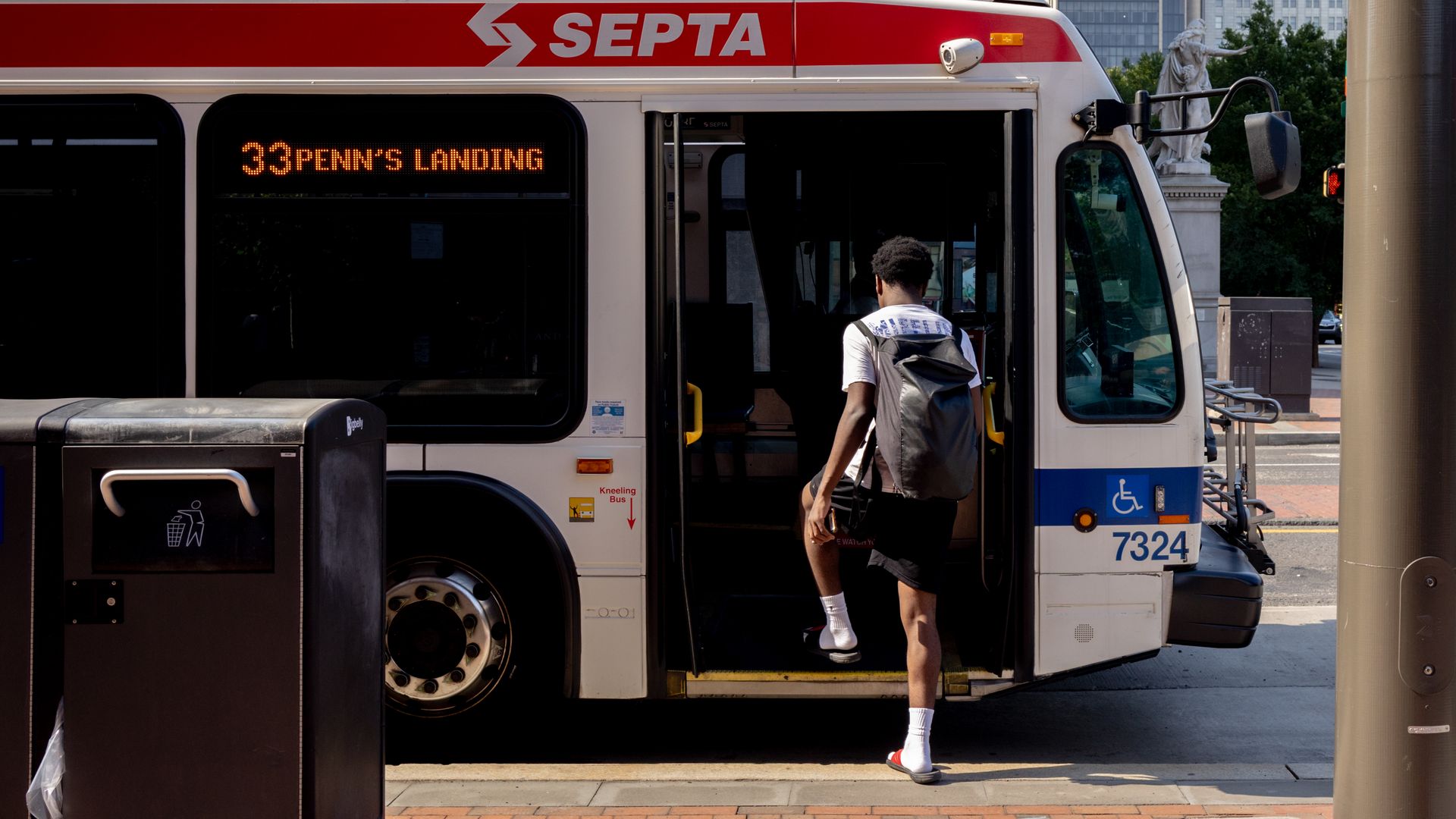 A commuter boards a SEPTA bus in Philadelphia over the summer.