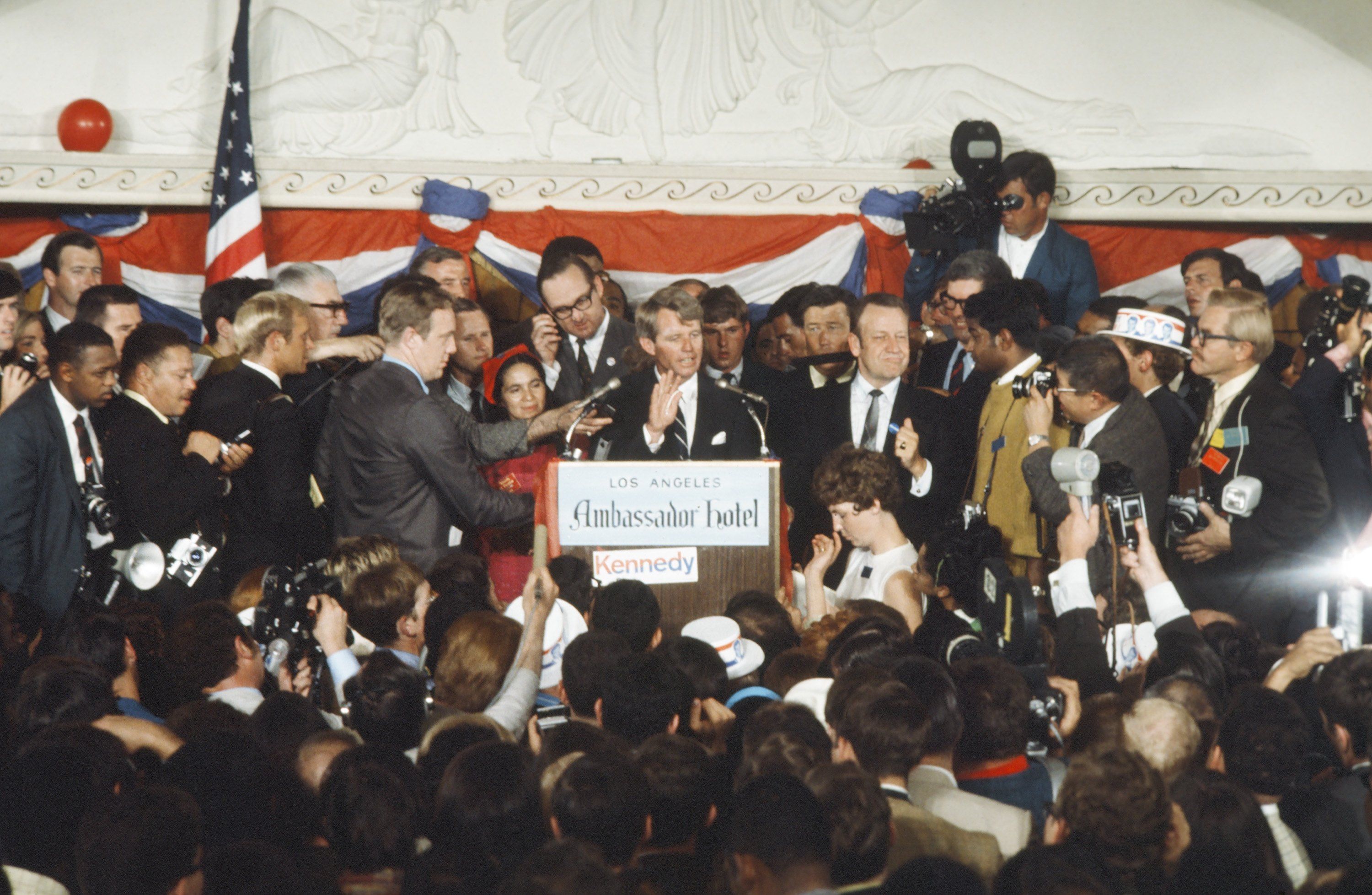 Dolores Huerta, in red, stands next to Sen. Robert F. Kennedy (D-NY) before he was fatally shot on June 5, 1968 during his Presidential Campaign at the Ambassador Hotel in Los Angeles. 