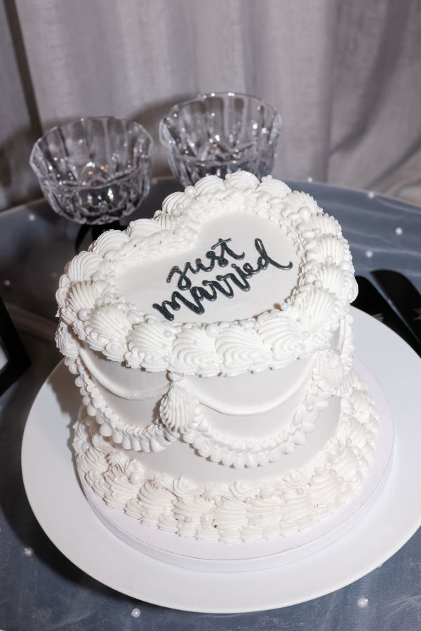 A heart-shaped wedding cake with vintage-style buttercream piping.
