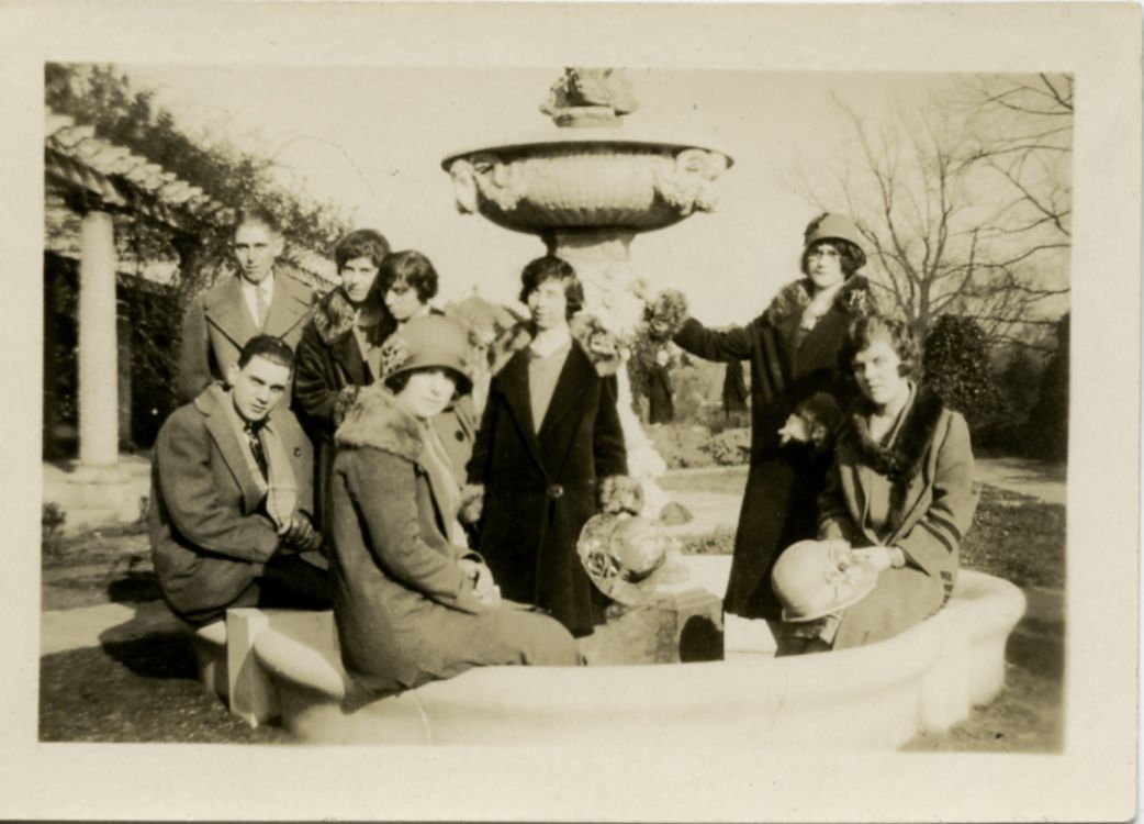 some circa 1930s looking people in a fountain 