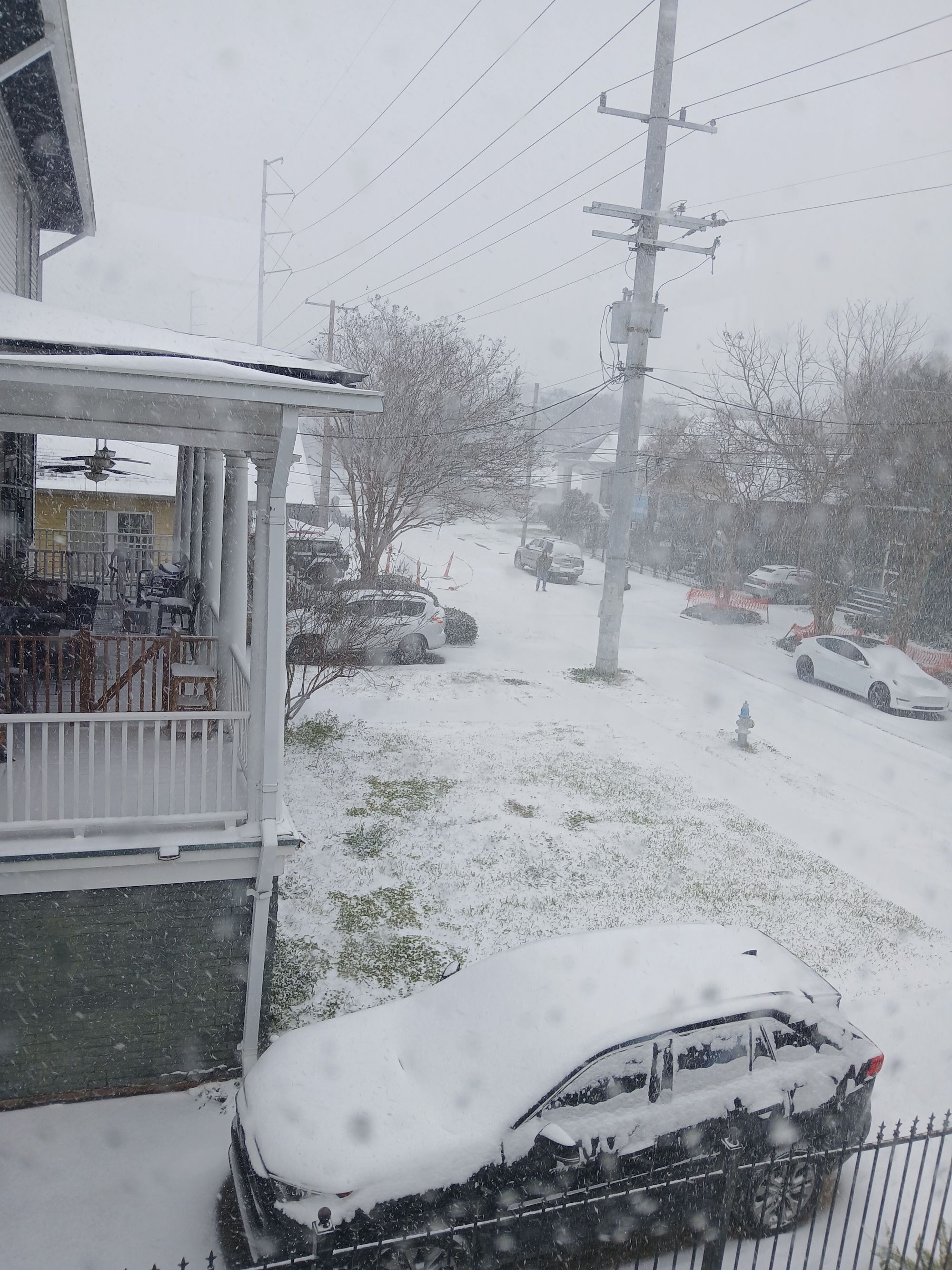 Photo shows a neighborhood in the snow.