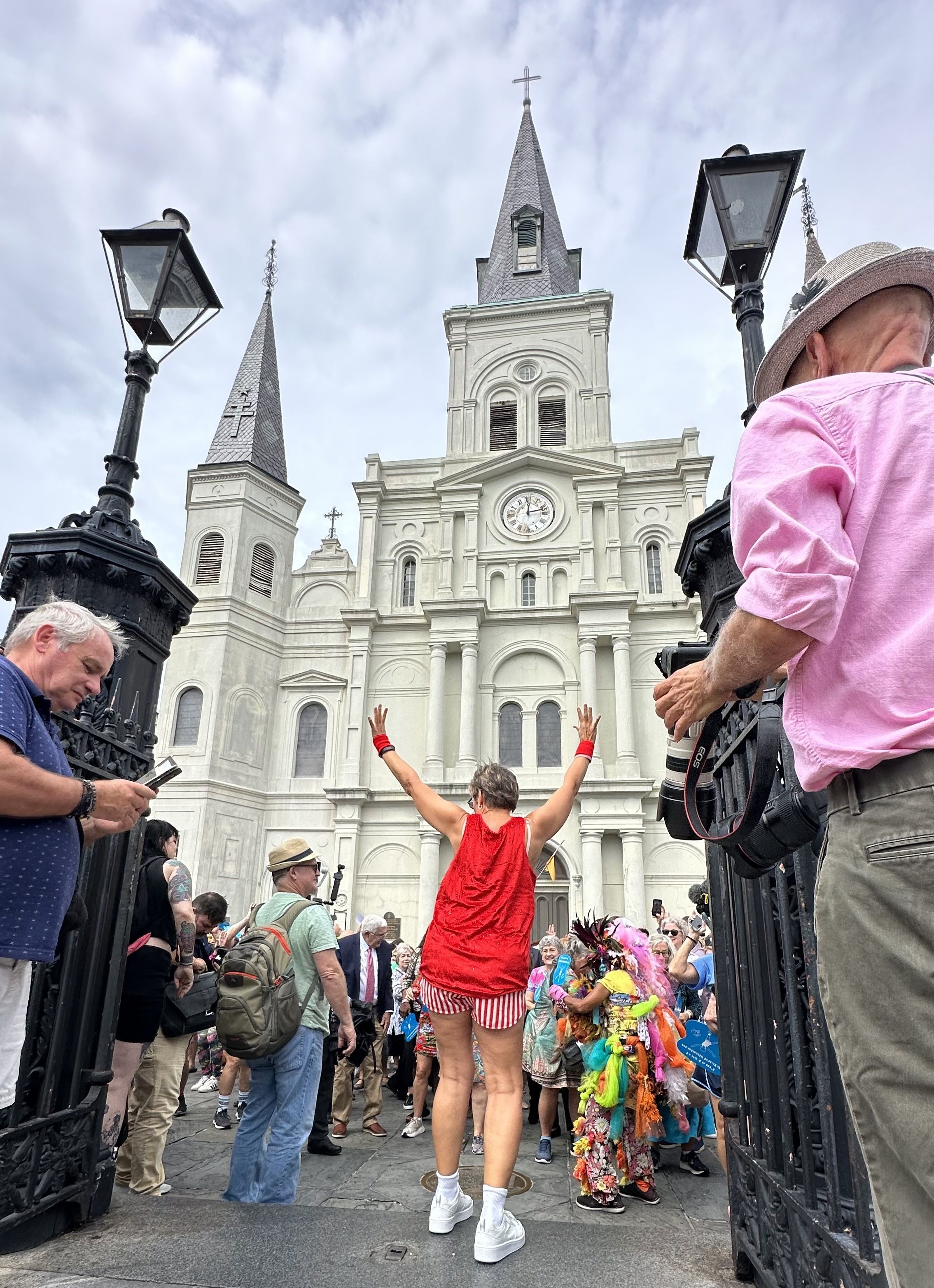 A person leads a workout in front of the St. Louis Cathedral.