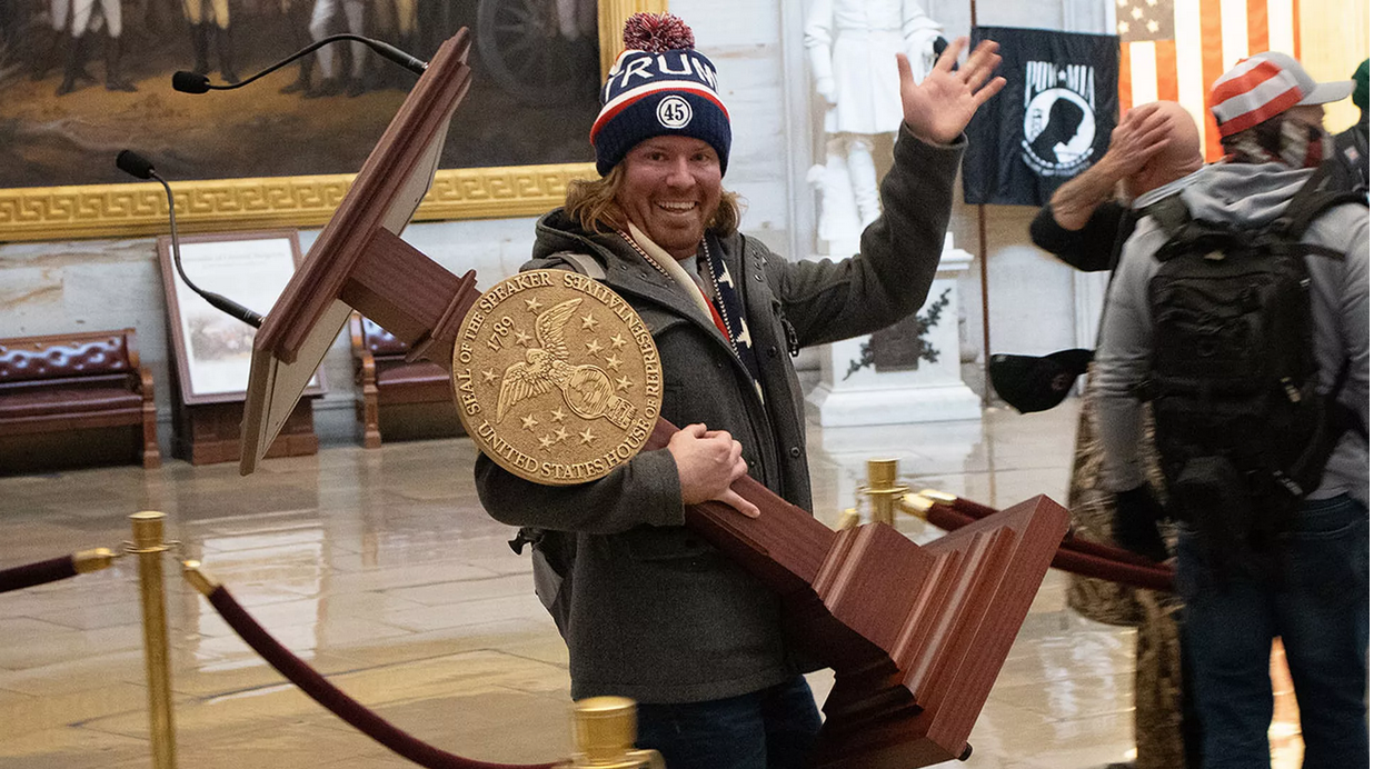 A man identified as Adam Johnson carries the lectern of Pelosi through the Roturnda of the U.S. Capitol Building after a pro-Trump mob stormed the building. 