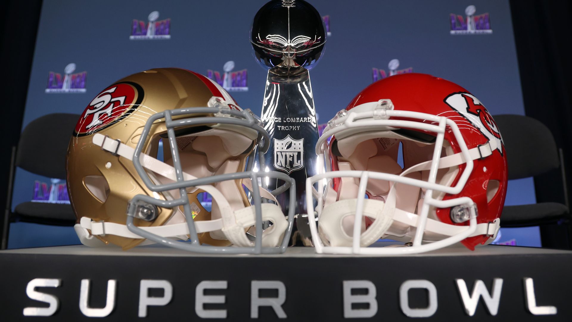 The helmets of Super Bowl LVIII participants San Francisco 49ers and Kansas City Chiefs and the Lombardi Trophy. 