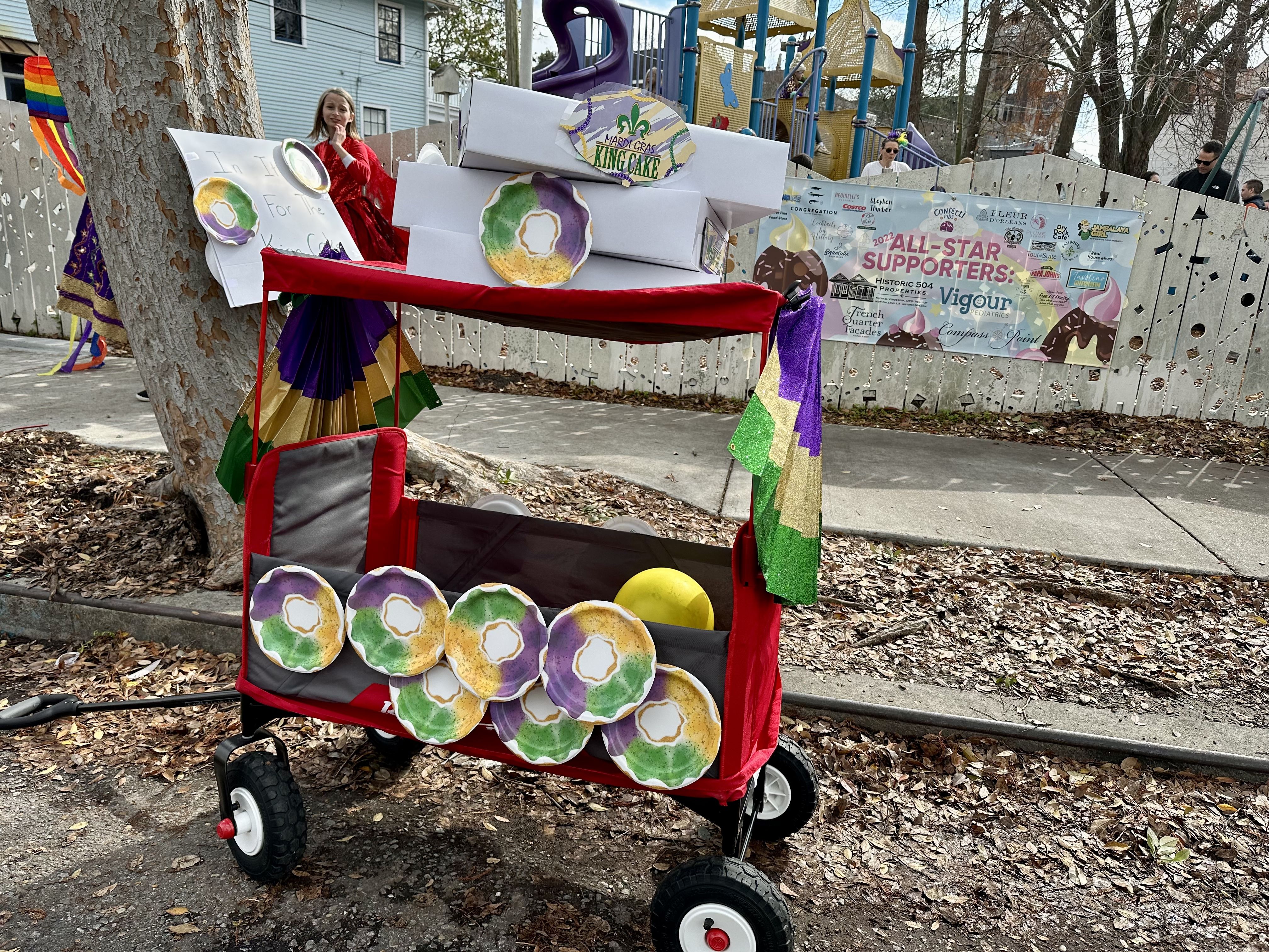 Photo shows a wagon float decorated with king cakes.