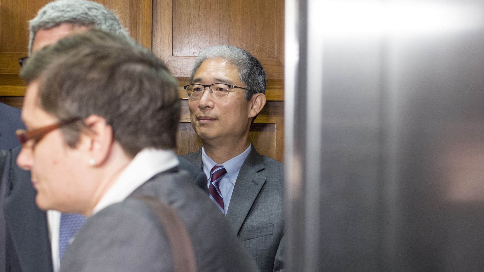 Bruce Ohr standing behind other men.