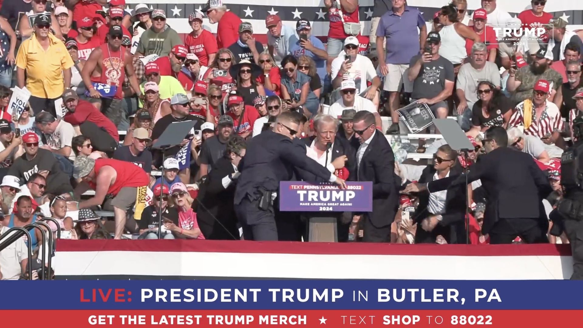 A screen grab captured from a video shows Republican presidential candidate former President Donald Trump appears to be injured after gunshots were reported as he is rushed offstage during a rally on July 13, 2024 in Butler, Pennsylvania.
