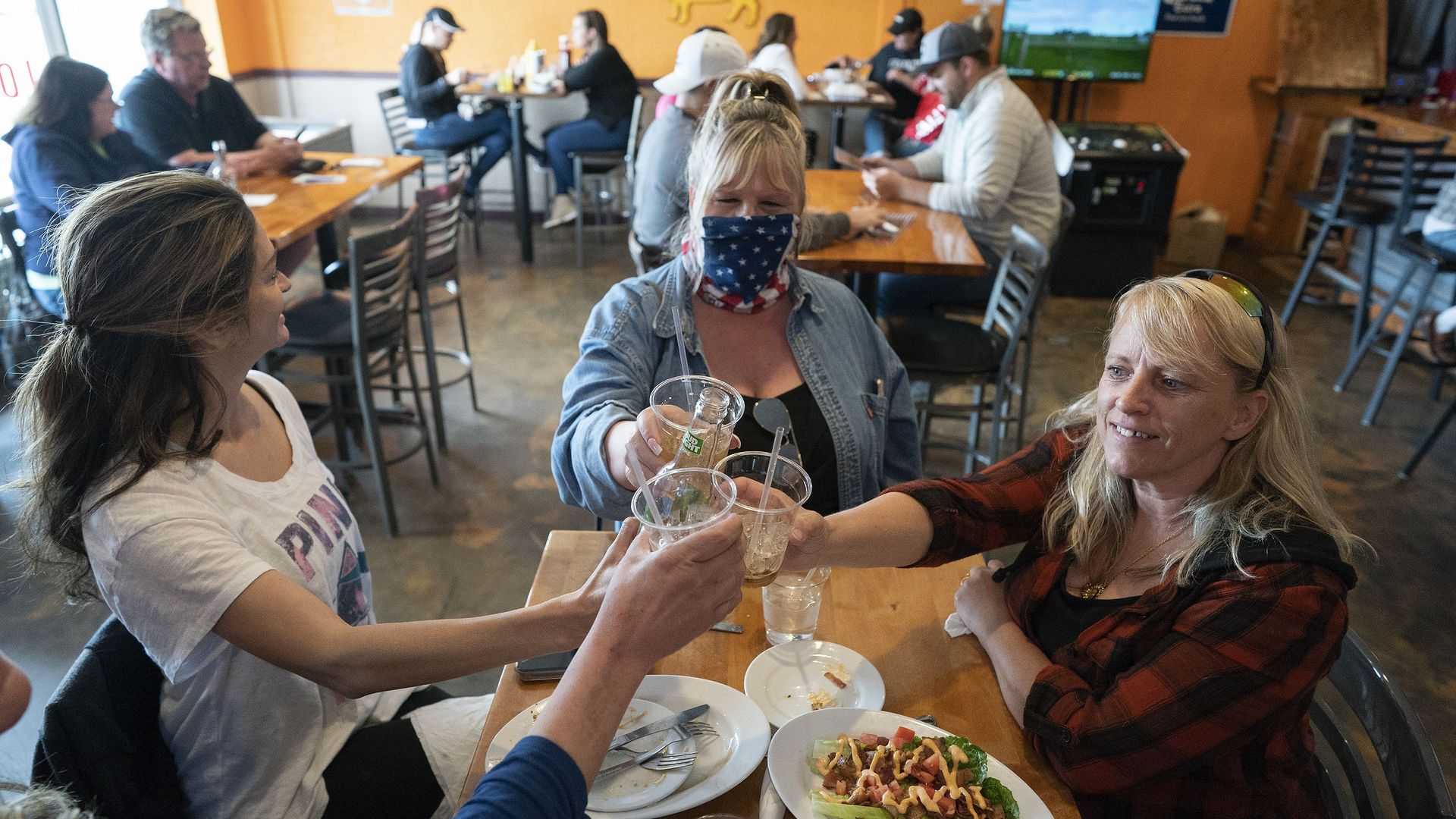 People enjoy a meal in Wisconsin, where the state supreme court overruled the governor on coronavirus lockdowns.