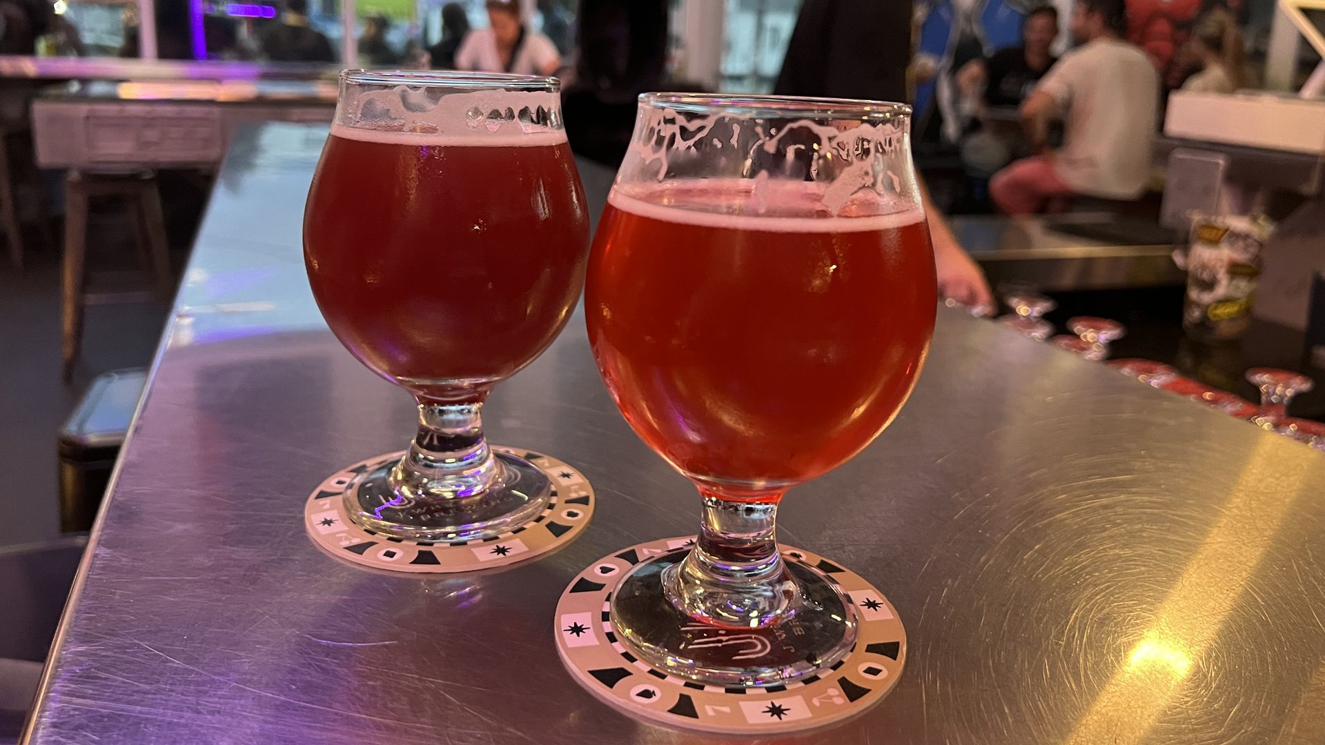 Two sour, red-tinted beers sit full on a metal bar in J Wakefield Brewing in Wynwood.
