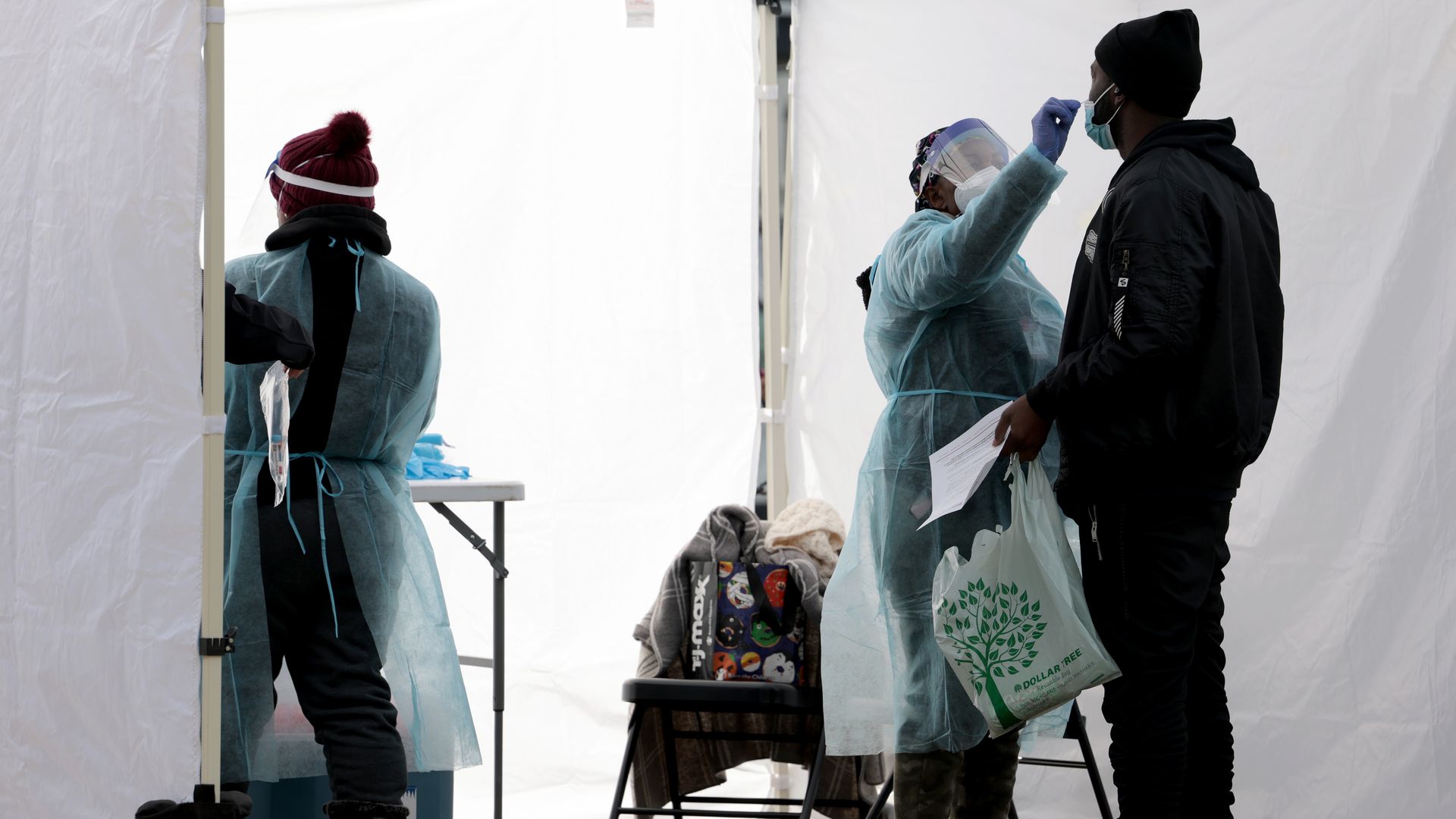 A healthcare worker administers a COVID-19 PCR test at a free test site in Farragut Square on December 28, 2021 in Washington, DC.