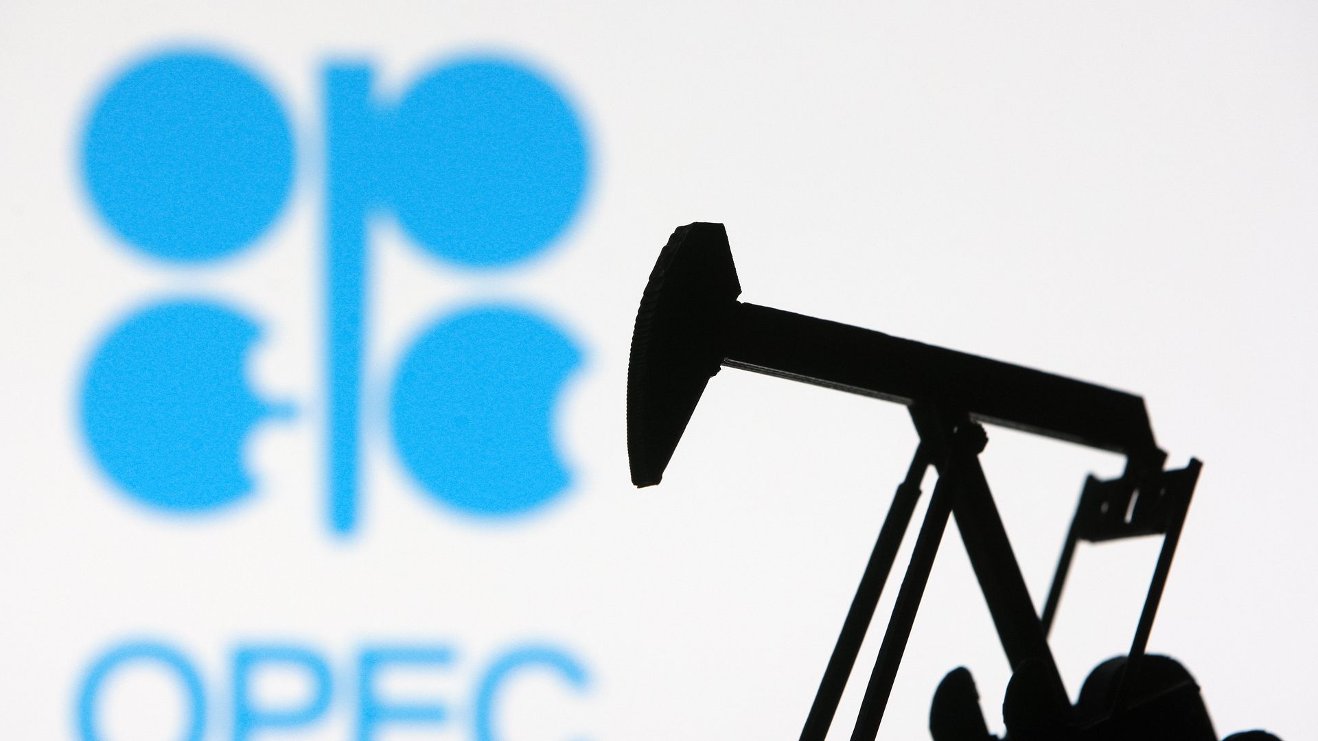 An OPEC logo behind a miniature model of an oil derrick pump in Kyiv, Ukraine, in 2021.