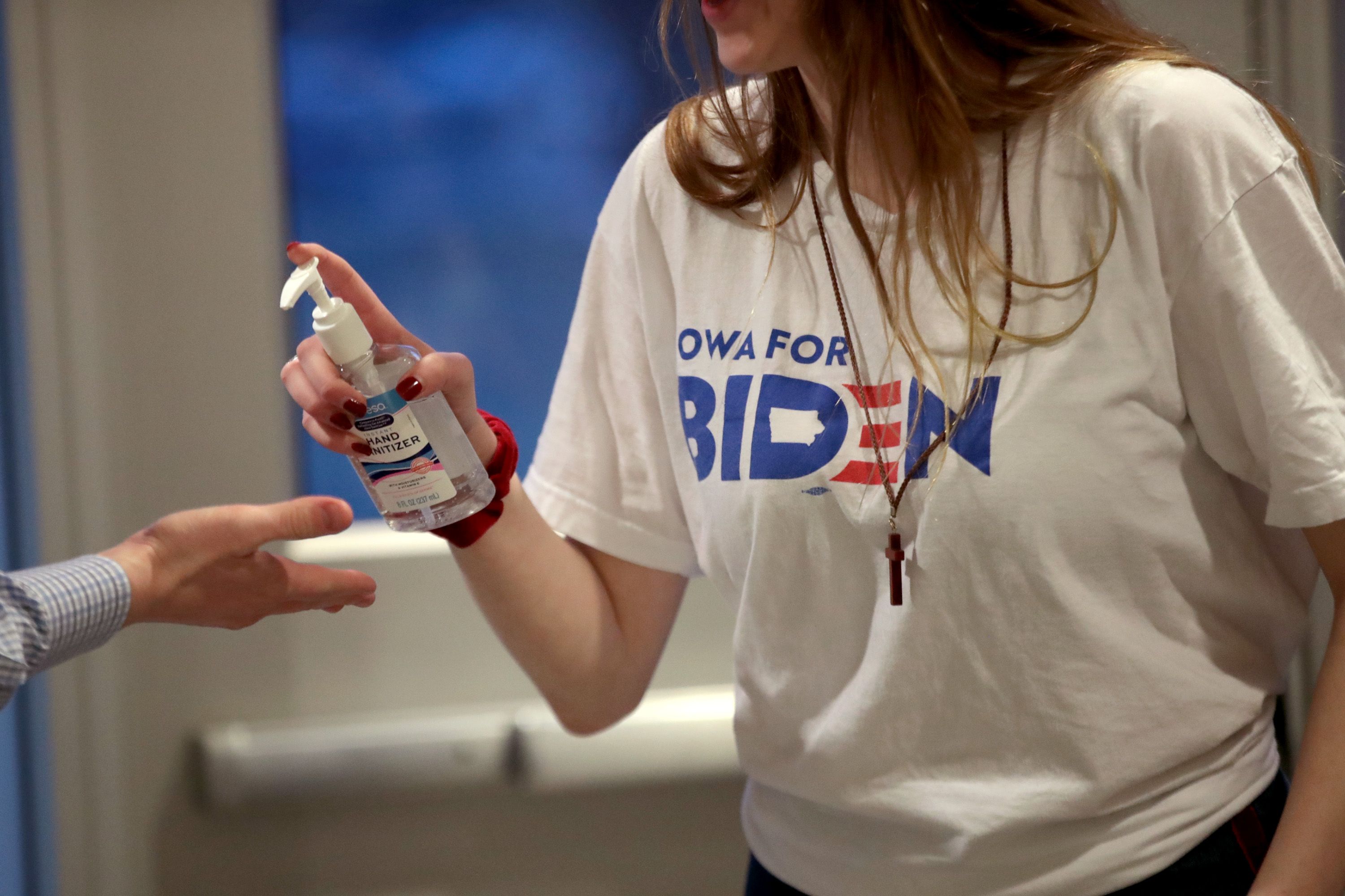 Campaign aide offers guests hand sanitizer before Biden rally