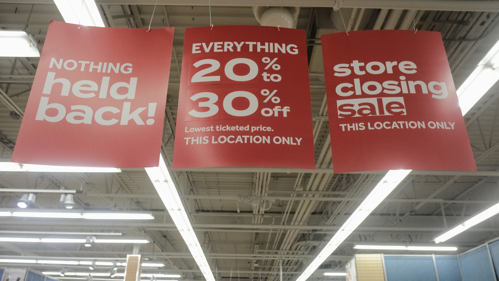 Sale signs in a Bed Bath and Beyond store