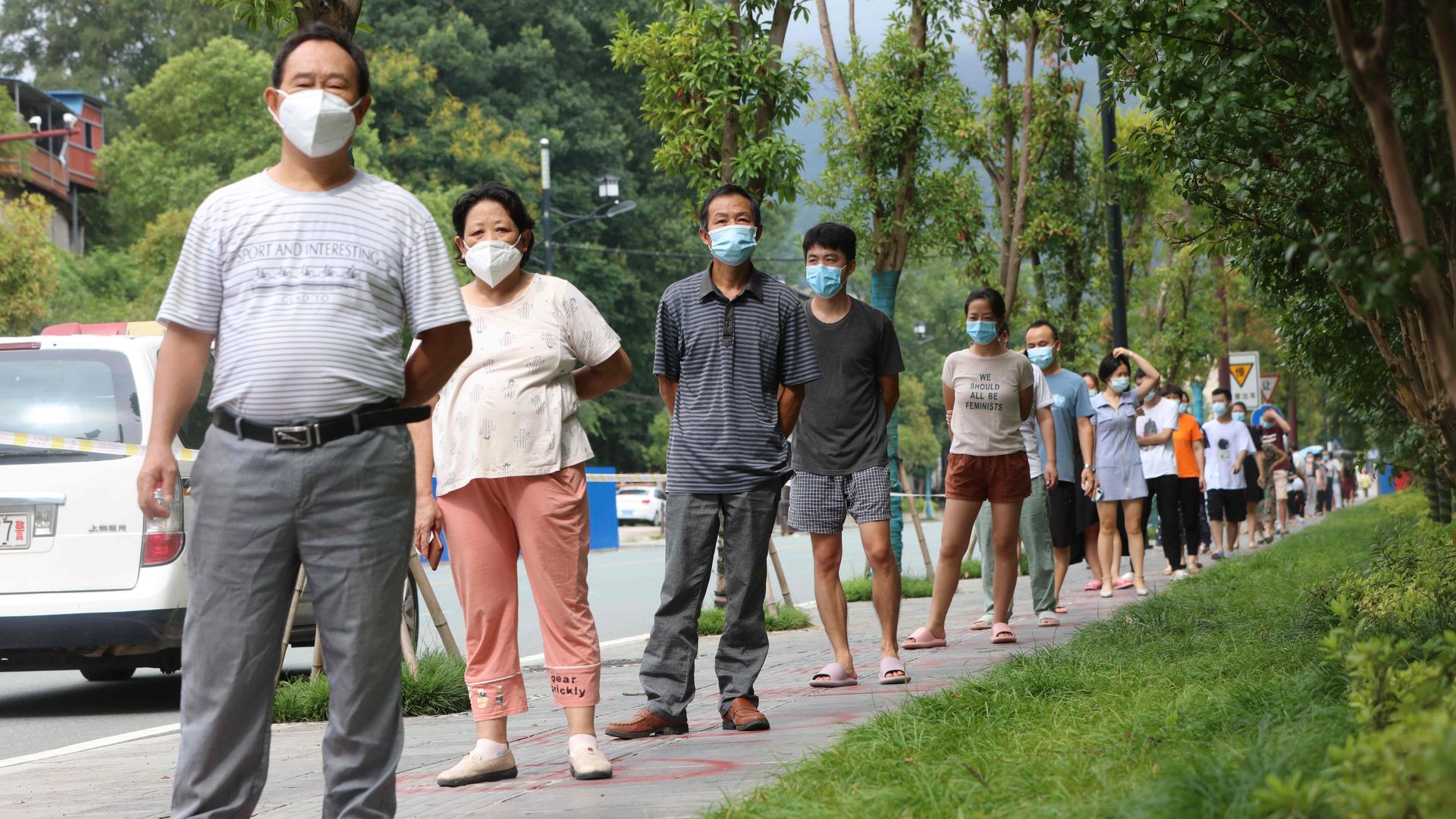 Local residents stand inside social distancing circles as they wait in a line for nucleic acid testing on Aug. 21.