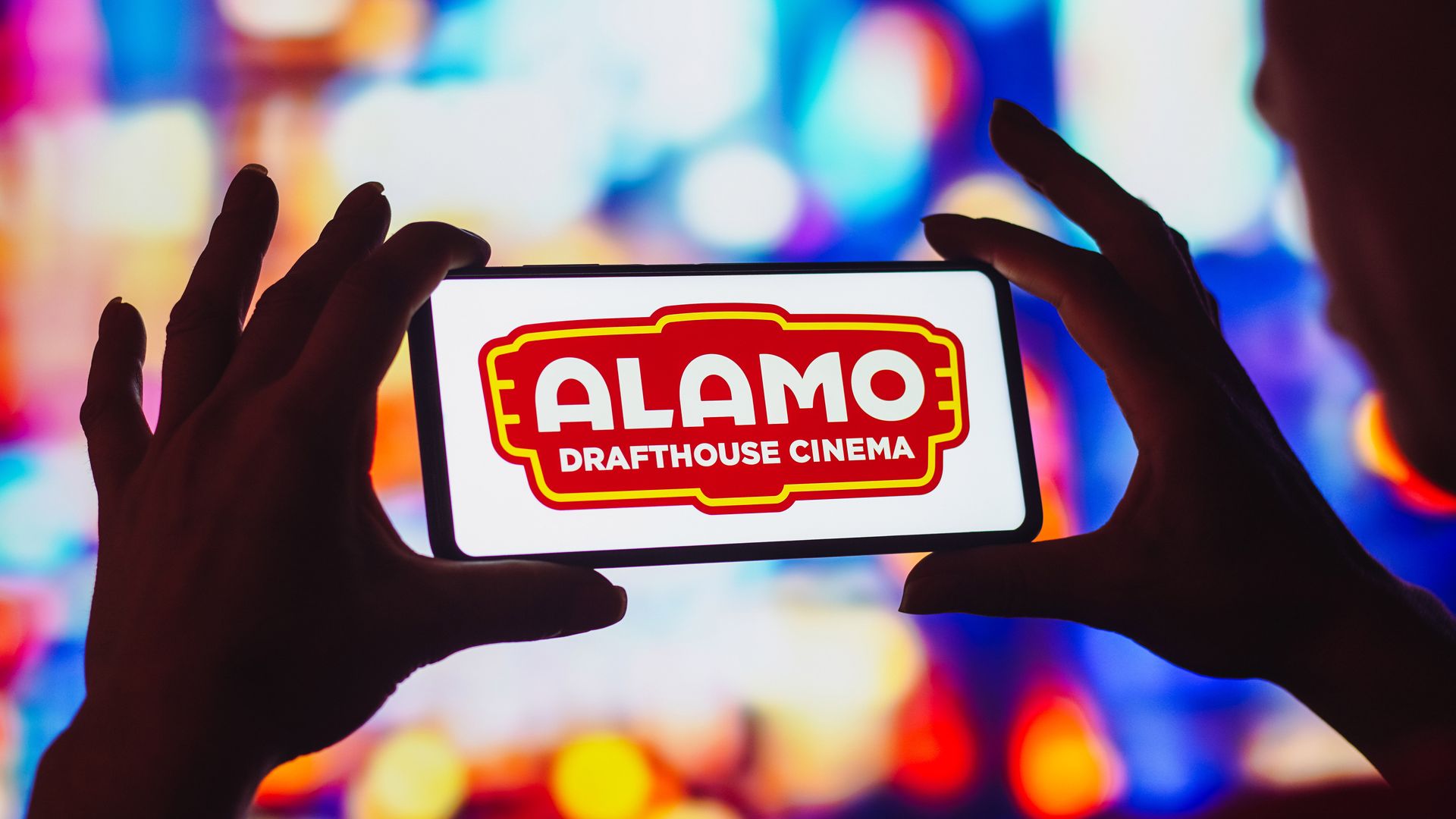 Alamo Drafthouse Cinema logo on smartphone