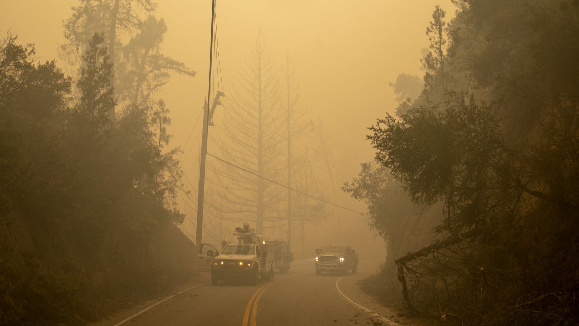 A PG&E crew seen through a hazy fog