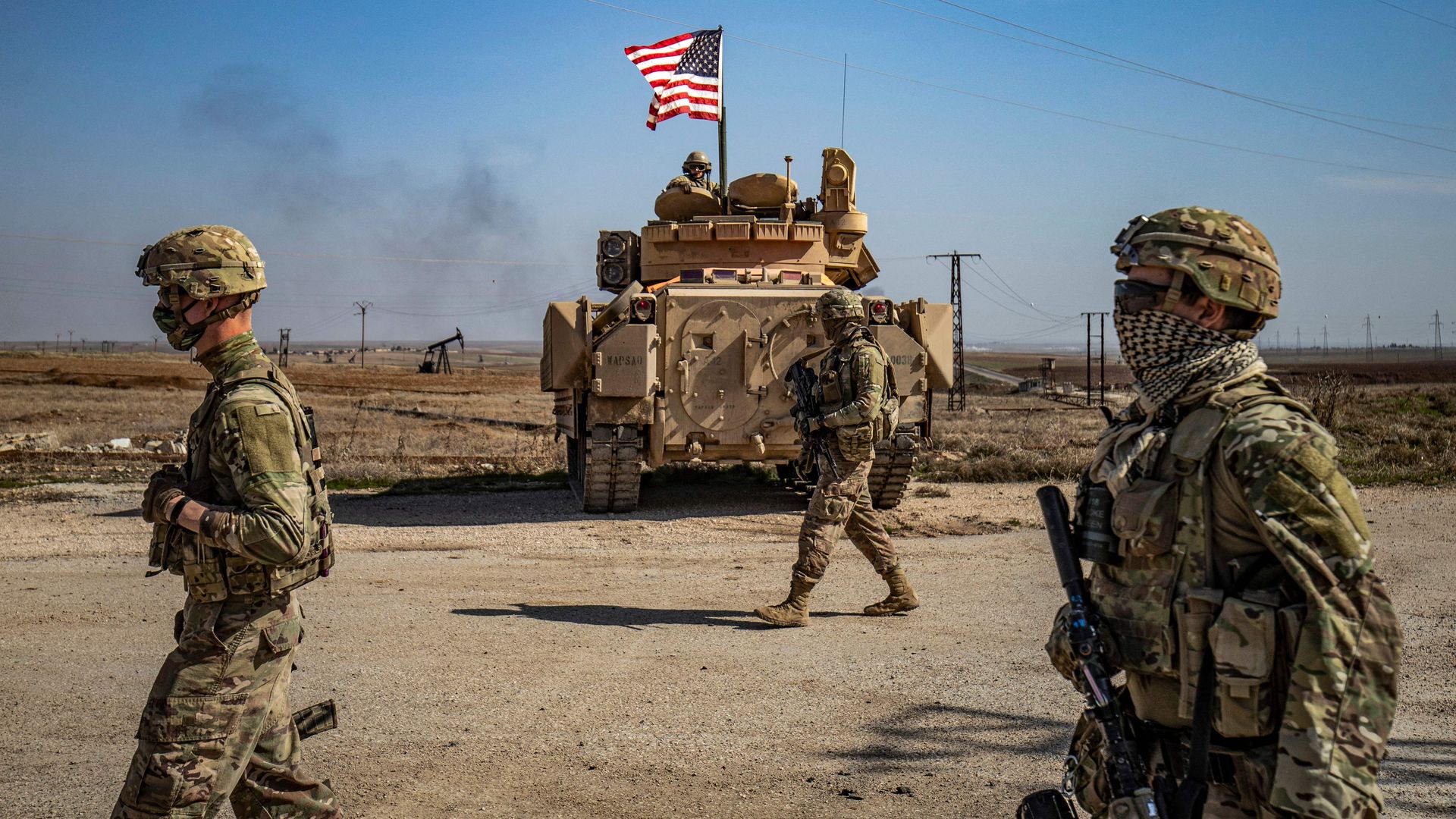  US soldiers walk while on patrol by the Suwaydiyah oil fields in Syria's northeastern Hasakah province on February 13, 2021. 