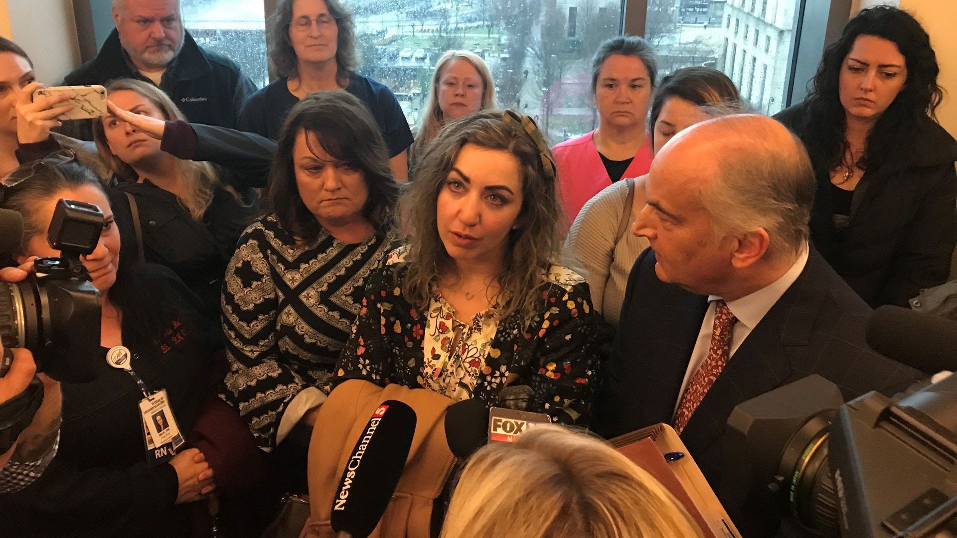 RaDonda Vaught, center, speaking to reporters after a court date. 
