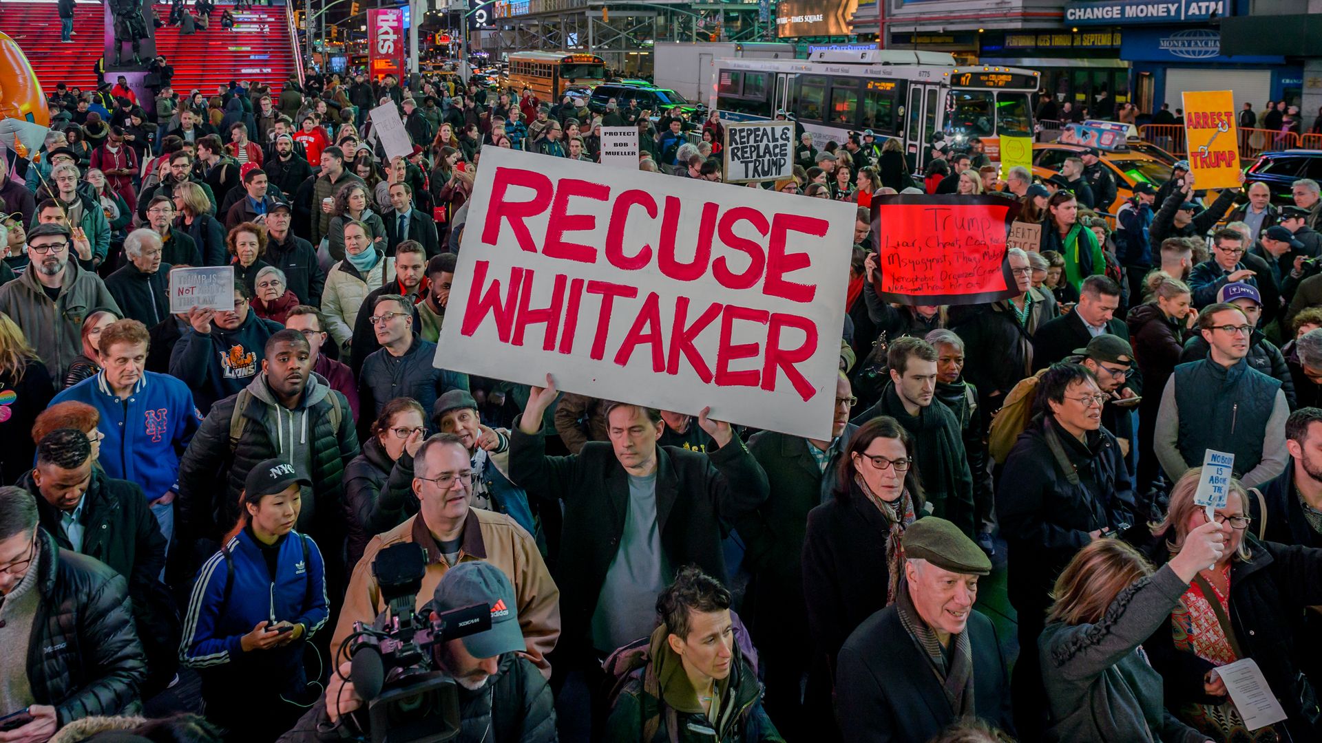 A crowd of people protesting with one big sign that reads, "Recuse Whitaker" in reference to the current acting attorney general matthew whitaker.