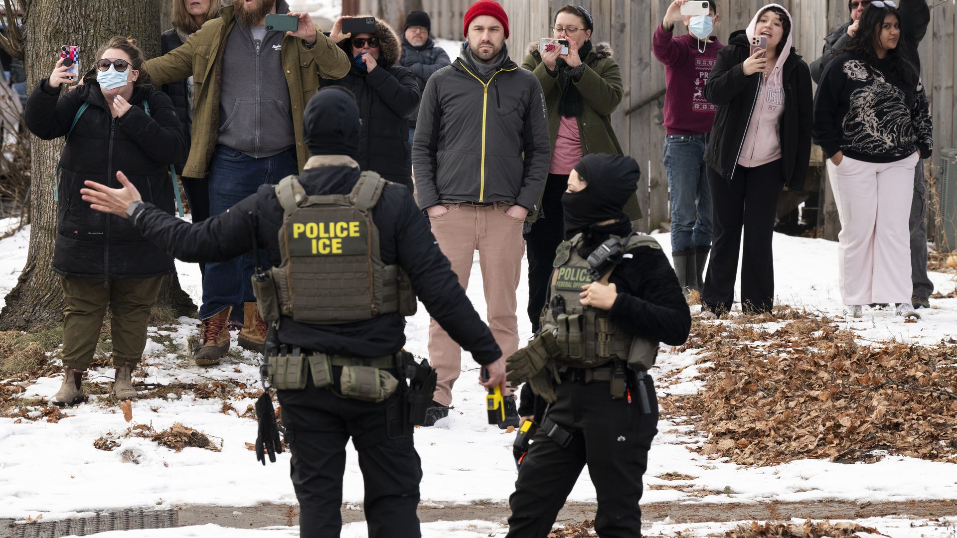 Observers film ICE agents on Penn Avenue in Minneapolis, Minn., on Feb. 5.
