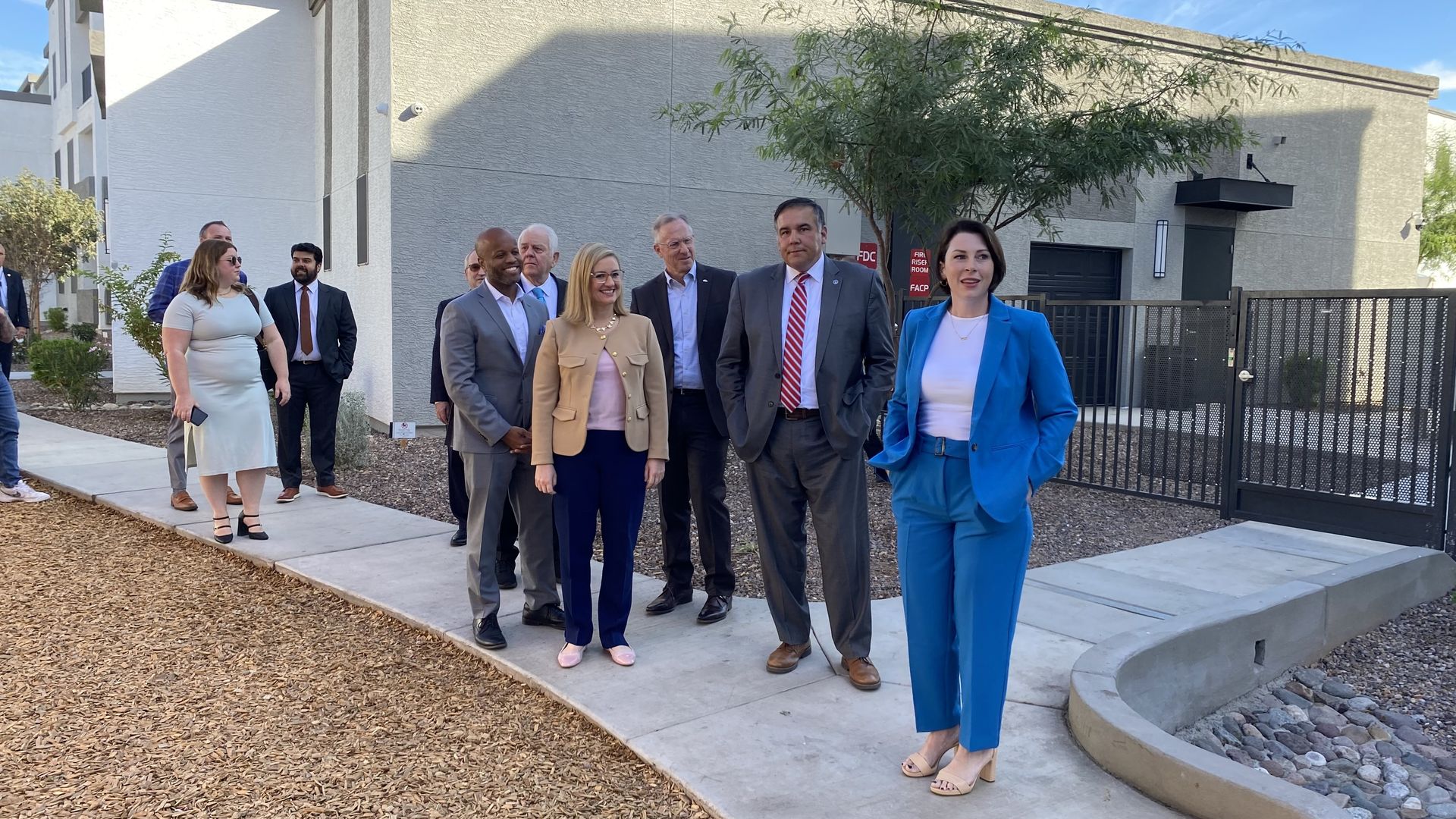 Jessica Raymond leads a group of people on a tour through an apartment complex.