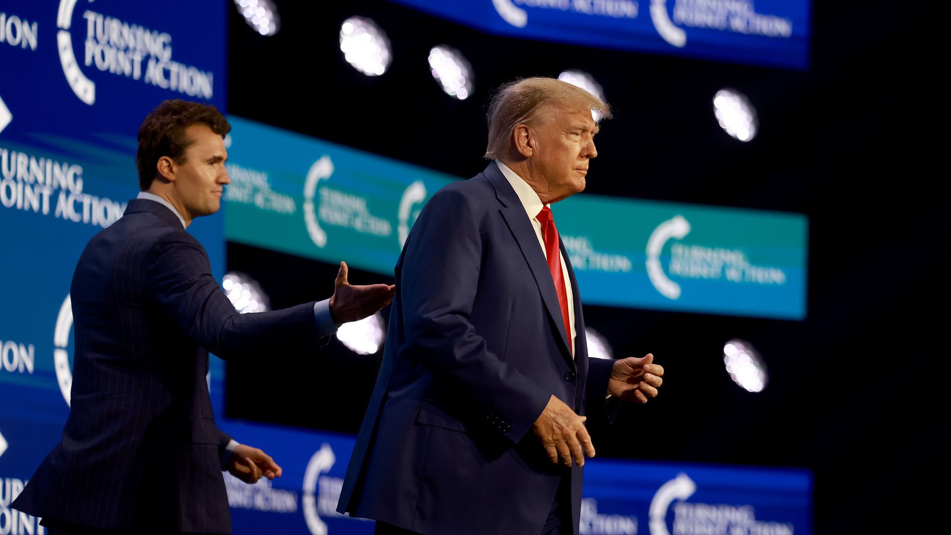 Former US President Donald Trump walks on stage after being introduced by Charlie Kirk (L) at the Turning Point Action conference as he continues his 2024 presidential campaign on July 15, 2023 in West Palm Beach, Florida. Trump spoke at the event held in the Palm Beach County Convention Center.