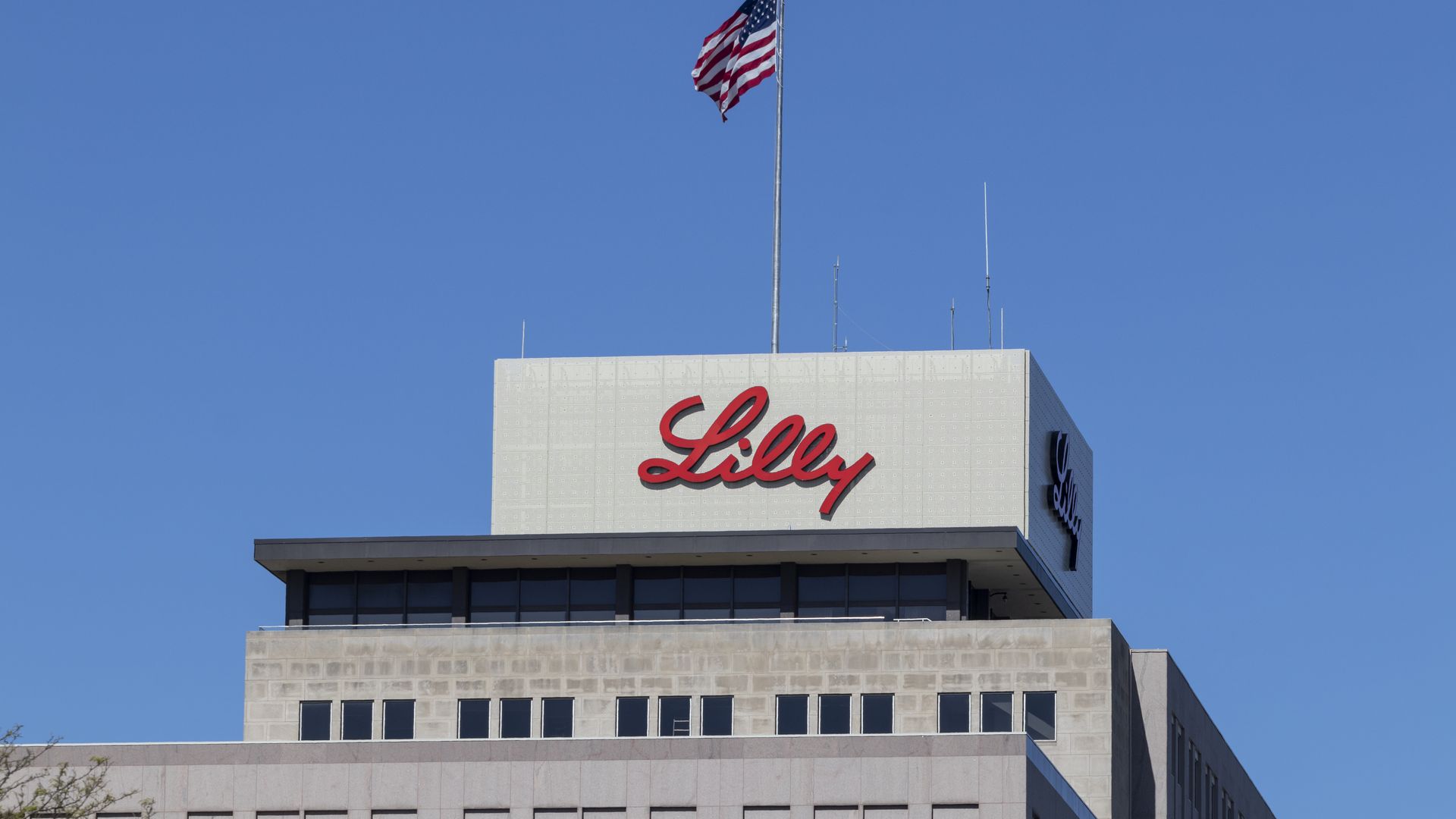 The top of the Eli Lilly Headquarters, showing the company logo, in Indianapolis.