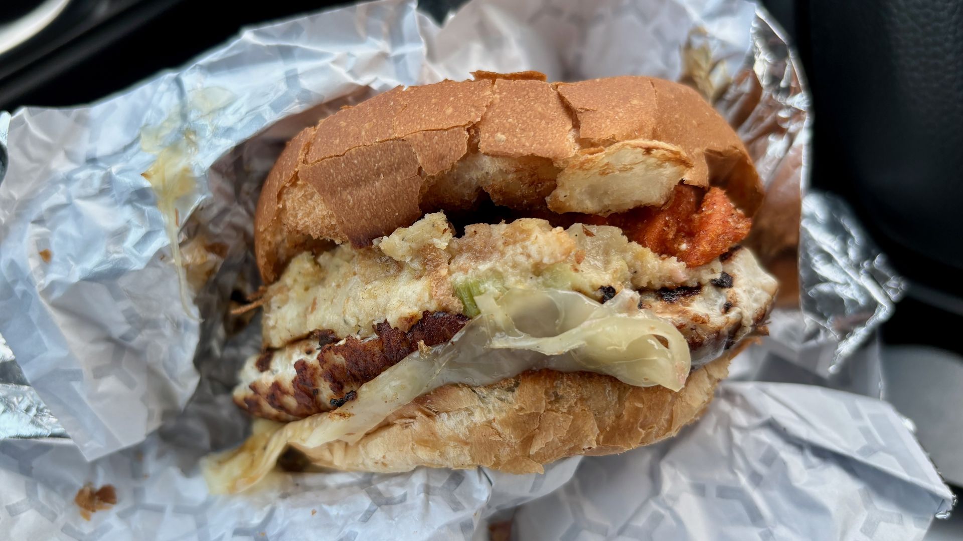 A close-up of the Swensons Thanksgiving on a Bun burger in a wrapper