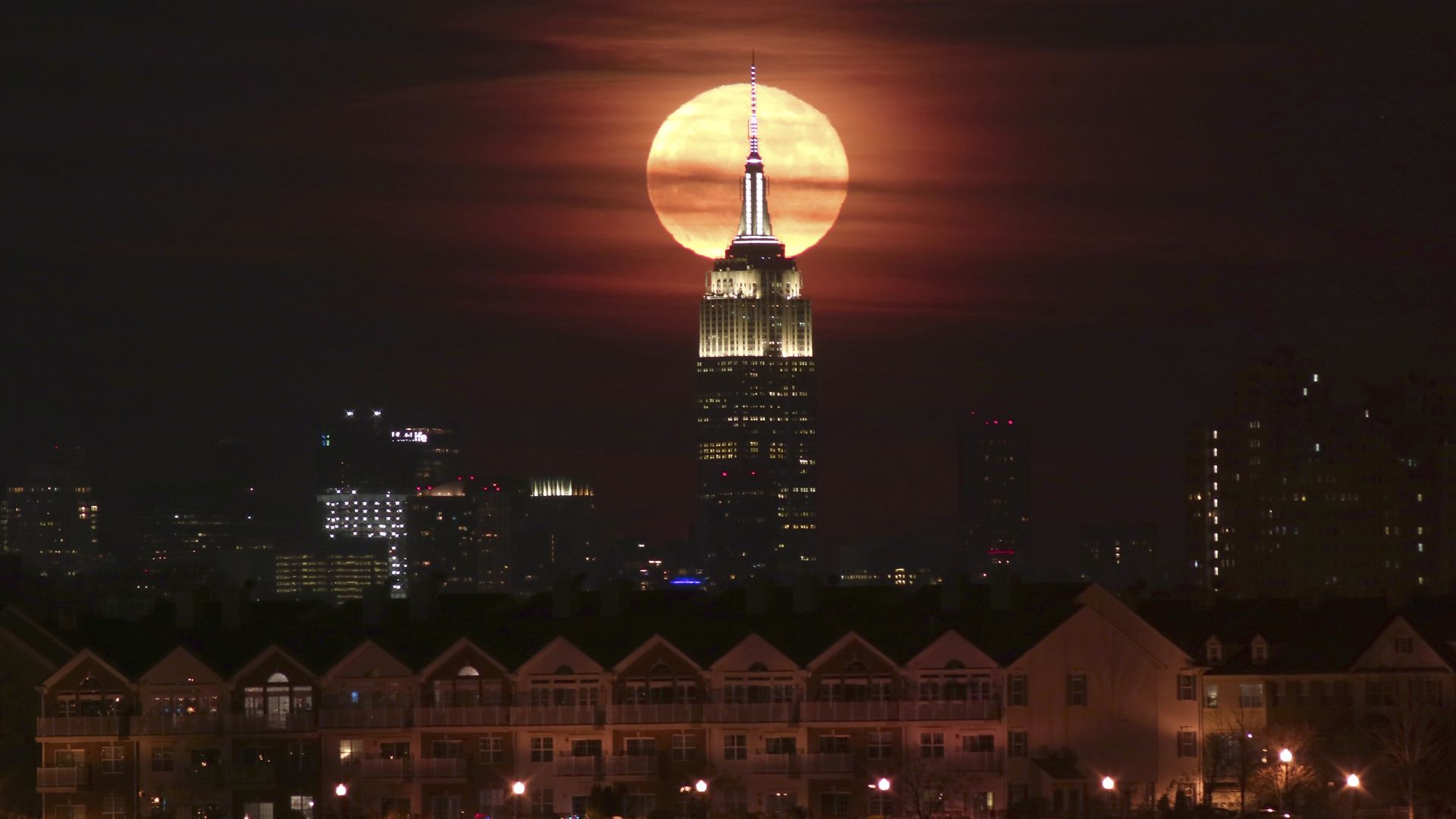 The full moon known at the Full Beaver or Frost Moon rises behind the Empire State Building in New York City on November 23, 2018 as seen from Newark, New Jersey.