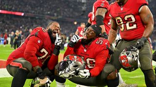 The buccaneers players pose for the camera.