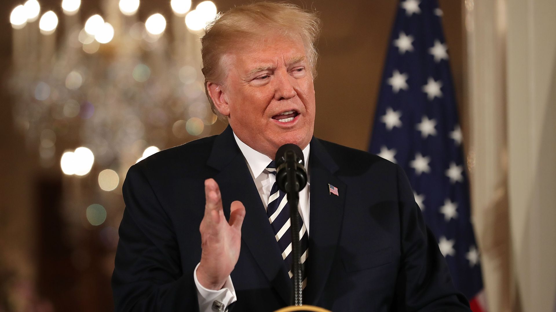Trump gestures at a podium