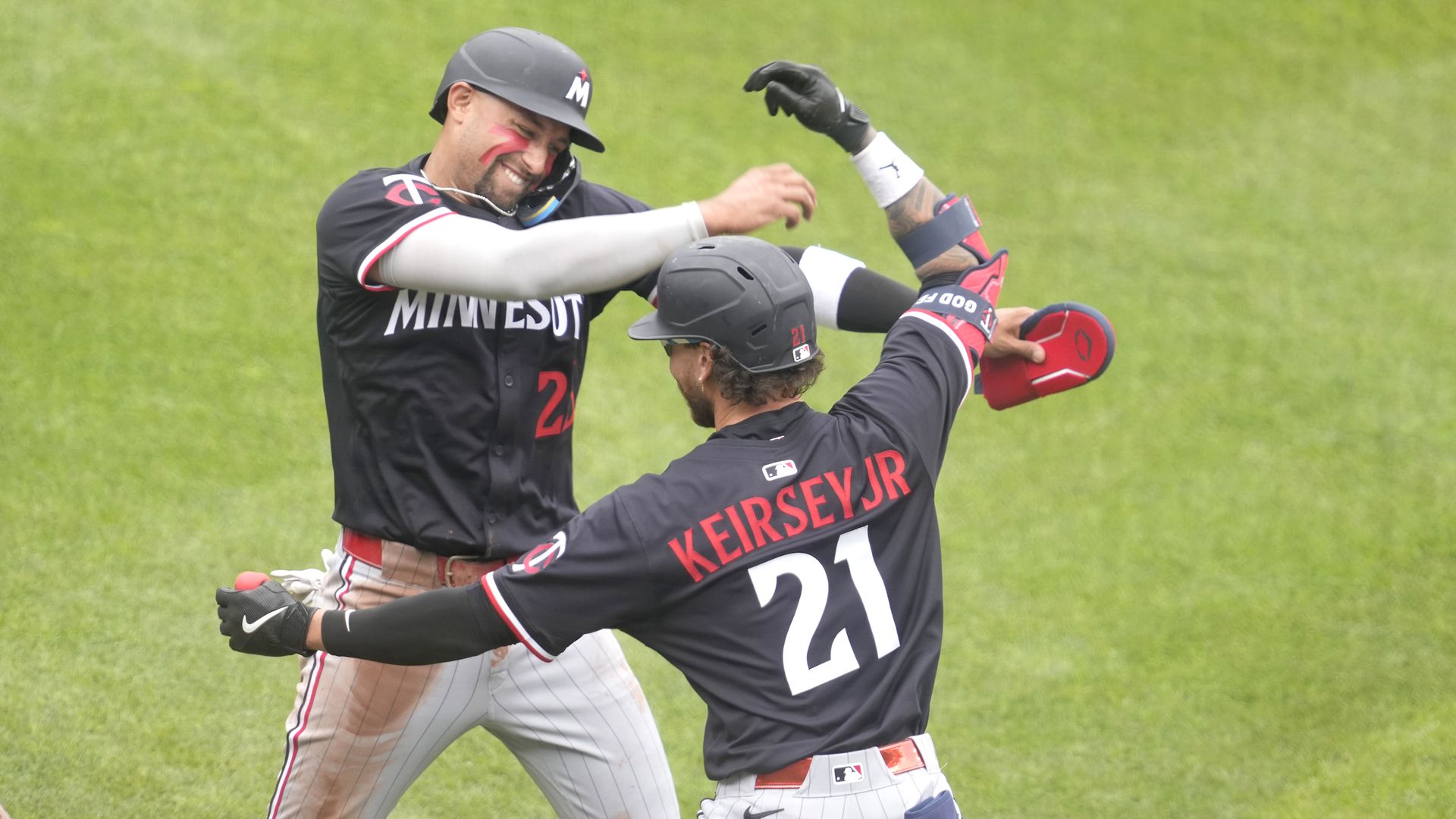 Two baseball players celebrate during a game after a home run