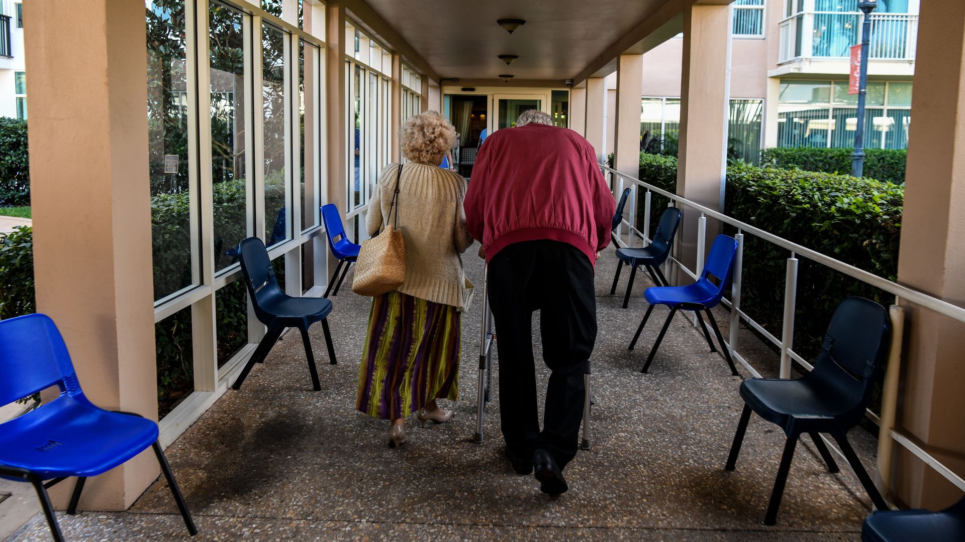 elderly residents walks inside a deserted hallway at the John Knox Village, a retirement community